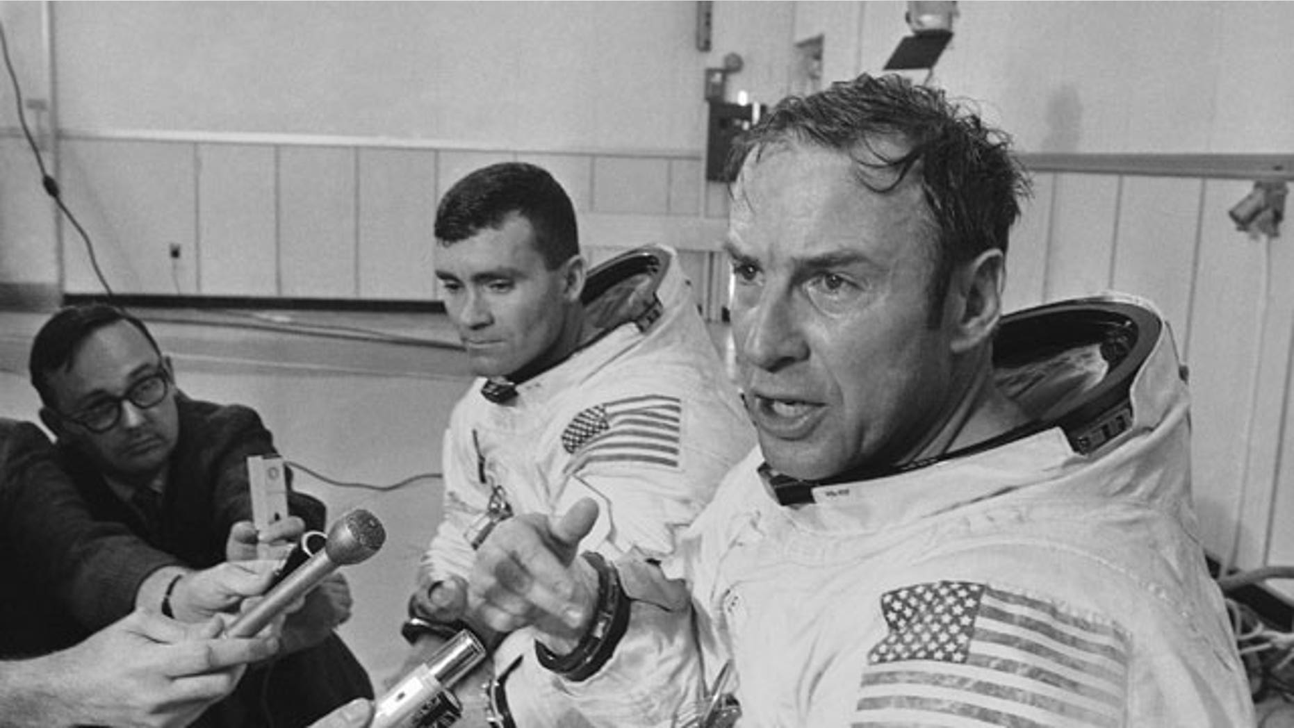 In this April 11, 1970 file photo, Apollo 13 commander James A. Lovell Jr., foreground, speaks during a news conference in Cape Kennedy, Fla. before the spacecraft launched on its ill-fated journey to the moon.