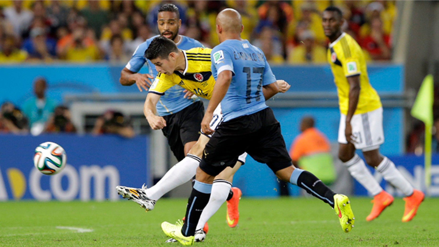James Rodriguez shoots to score his team's first goal during the World Cup, on June 28, 2014.