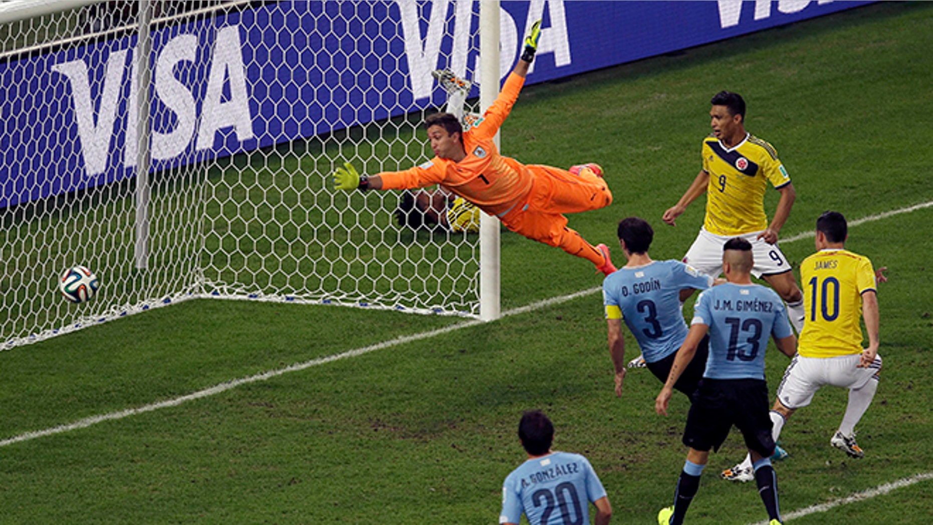 Colombia's James Rodriguez, right, scores his side's second goal past Uruguay's goalkeeper Fernando Muslera during the World Cup round of 16 soccer match between Colombia and Uruguay at the Maracana Stadium in Rio de Janeiro, Brazil, Saturday, June 28, 2014. (AP Photo/Themba Hadebe)