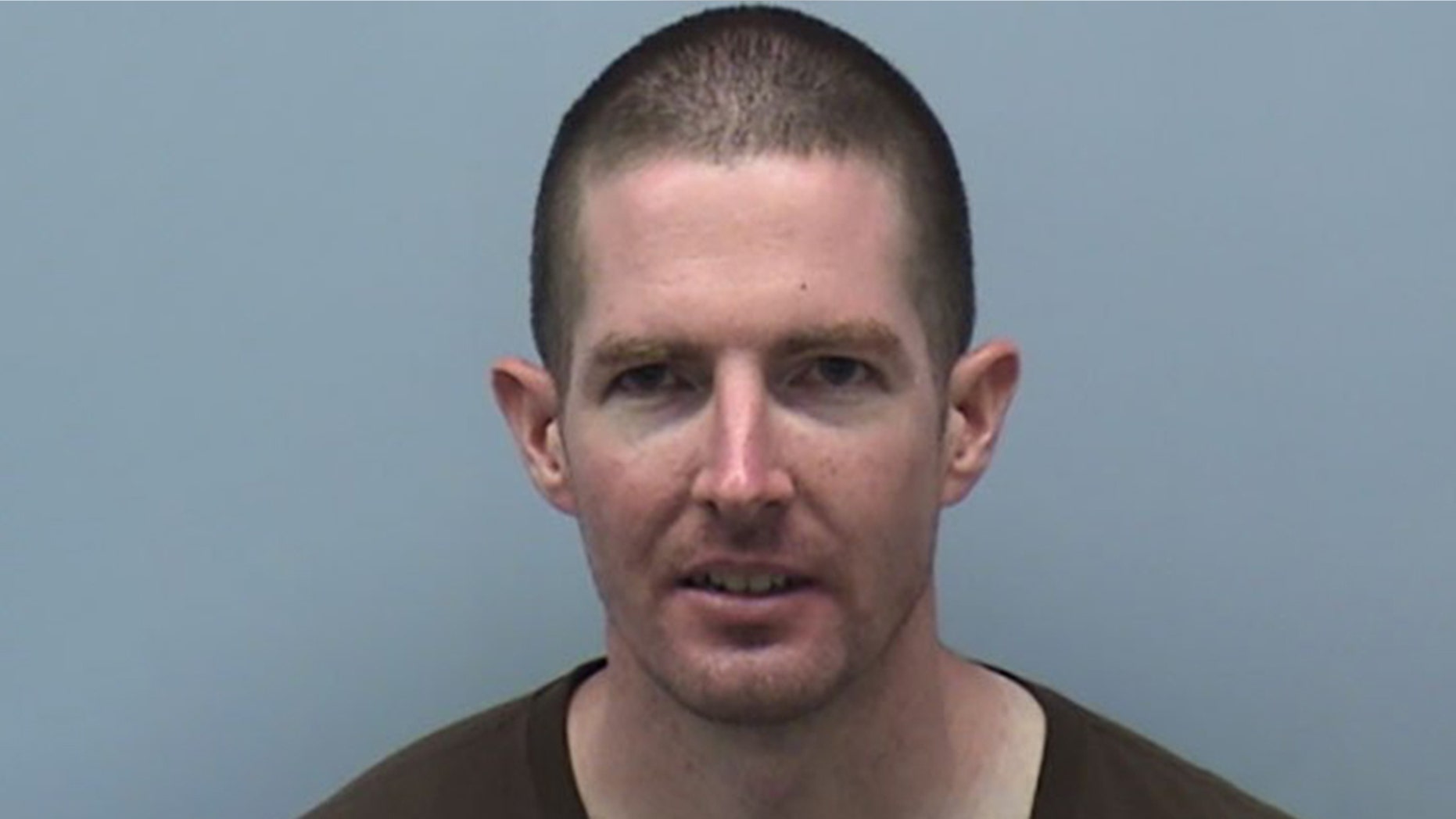 James Trainor was arrested Monday after allegedly throwing a brick at the glass door of Sen. Mark Warner's Virginia office. Police said they do not believe the vandalism was random.