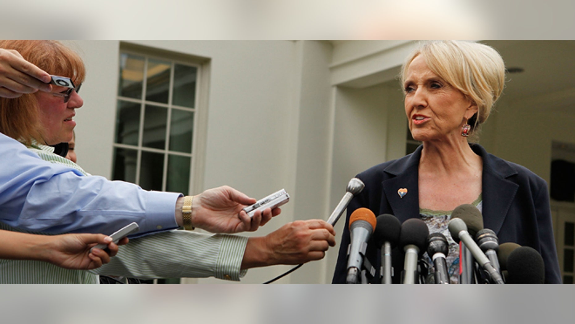 Arizona Governor Jan Brewer (R) takes questions from members of the news media outside the West Wing at the White House after meeting with U.S. President Barack Obama June 3, 2010 in Washington, DC. (Photo by Chip Somodevilla/Getty Images)