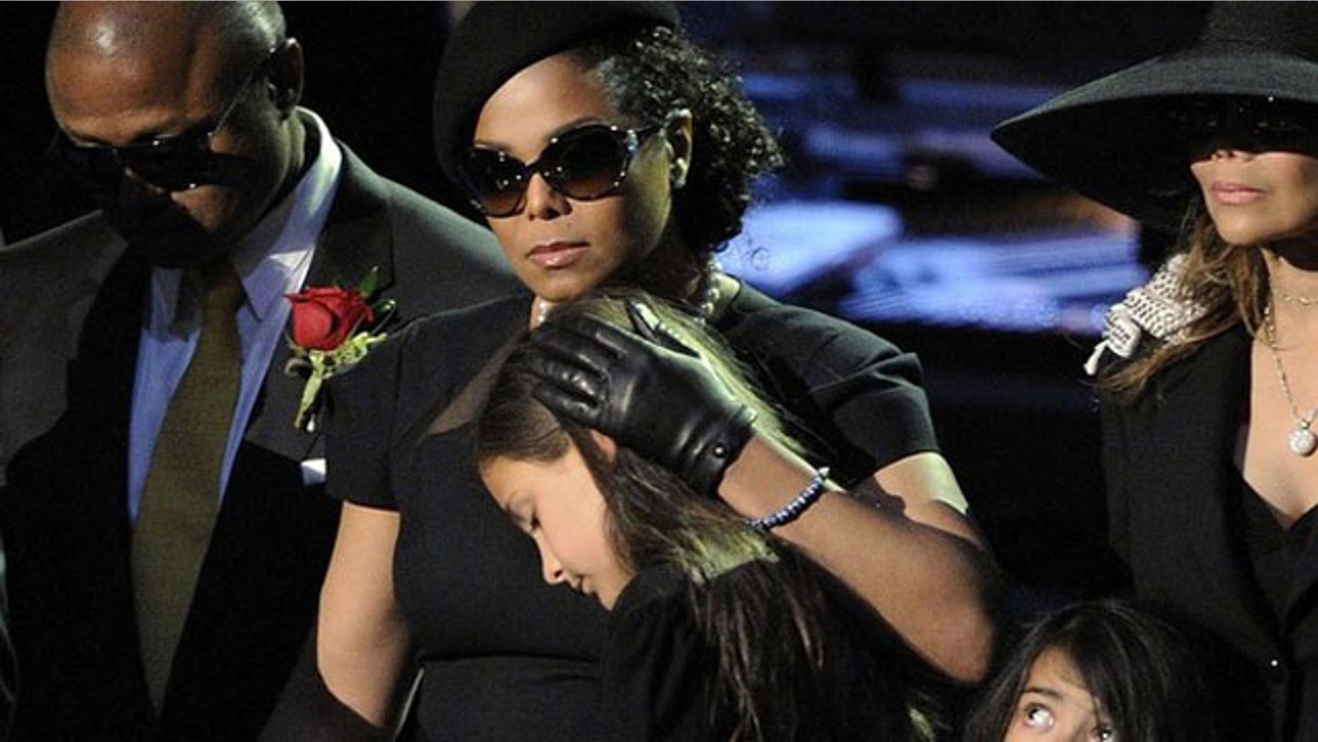 July 7: Paris Katherine Jackson, daughter of Michael Jackson, leans on Janet Jackson, sister of the late pop star, at the Michael Jackson public memorial service held at Staples Center in Los Angeles.