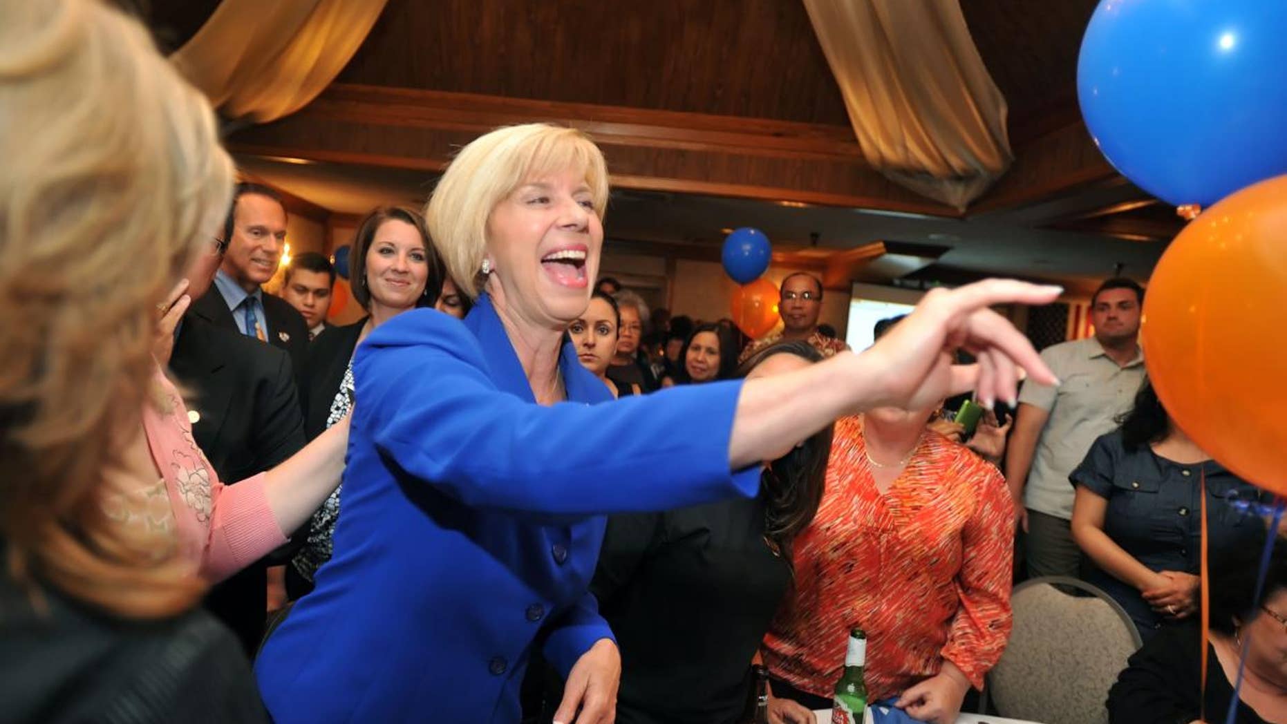 Los Angeles City councilwoman Janice Hahn, running for Congressional District 36th, makes her way through the crowd of supporters Tuesday night July 12, 2011 at her election party. (AP Photo/Sean Hiller - Daily Breeze)