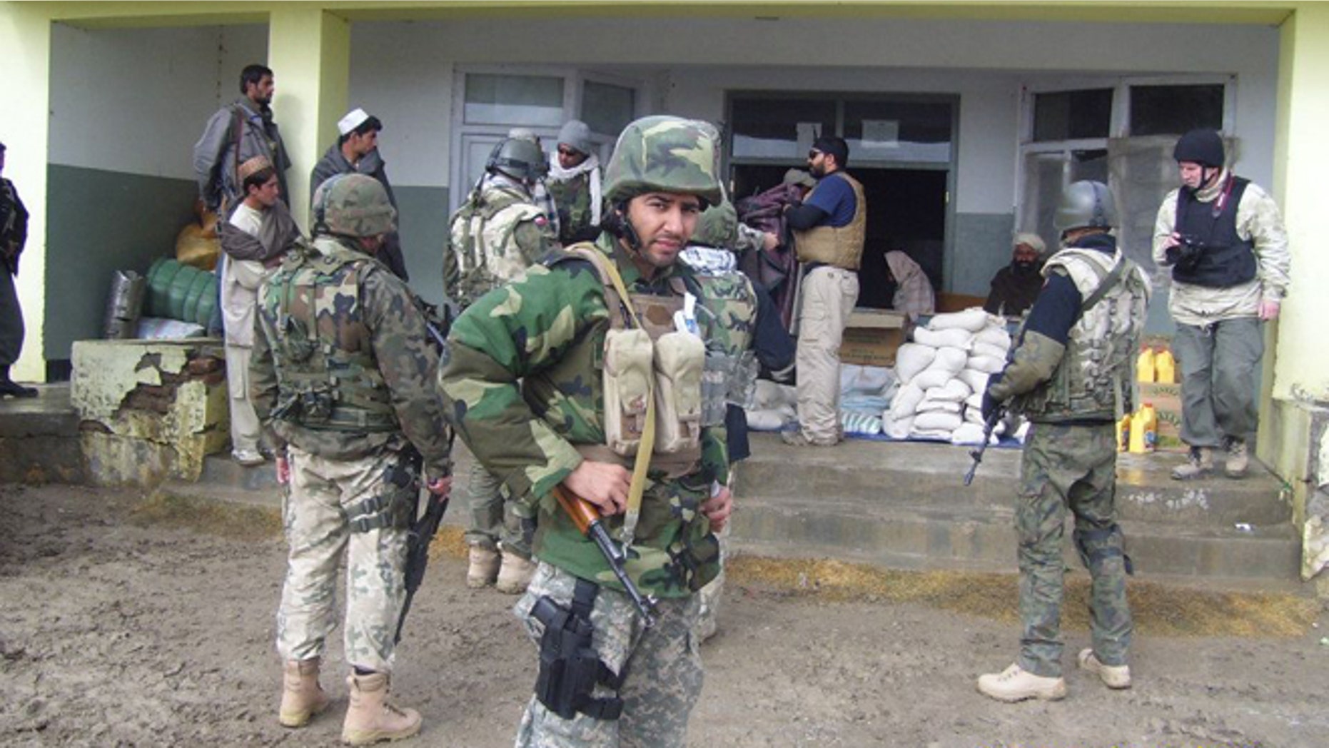 Janis Shinwary (foreground) was granted U.S. visa status earlier this month for his assistance to military forces in Afghanistan -- but now his status is under review and he has been left a potential target of Taliban militants.