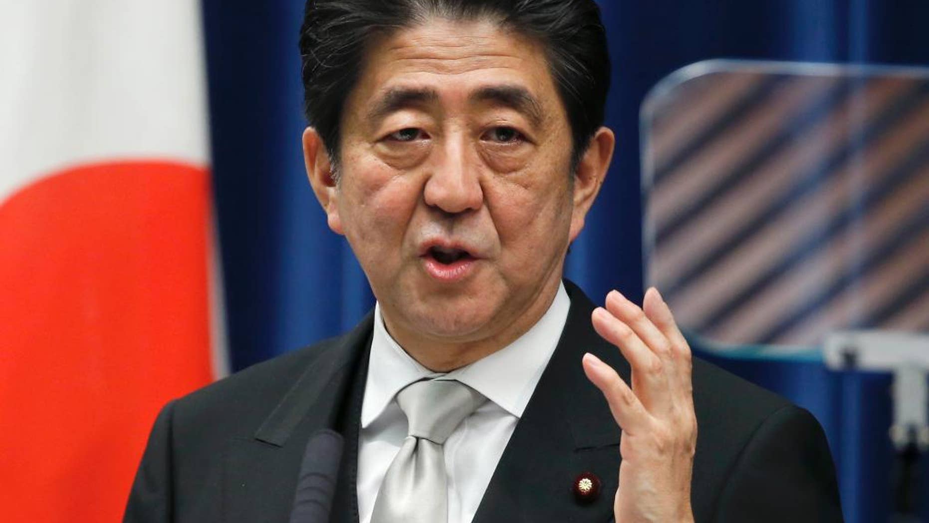 FILE - In this Wednesday, Dec. 24, 2014 file photo, Japan's Prime Minister Shinzo Abe speaks during a press conference at his official residence in Tokyo after taking office for a third term as prime minister. Japan's Cabinet approved a record 96.3 trillion yen ($814 billion) government budget for the coming fiscal year Wednesday, Jan. 14, 2015. (AP Photo/Shizuo Kambayashi, File)