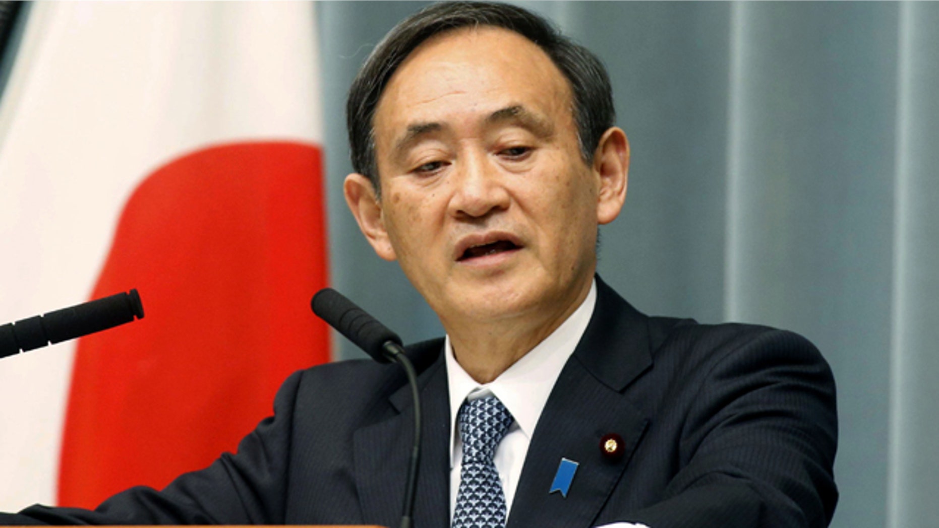 Jan. 26, 2015: Japan's government spokesman Yoshihide Suga speaks at a press conference in Tokyo. (AP Photo/Kyodo News)