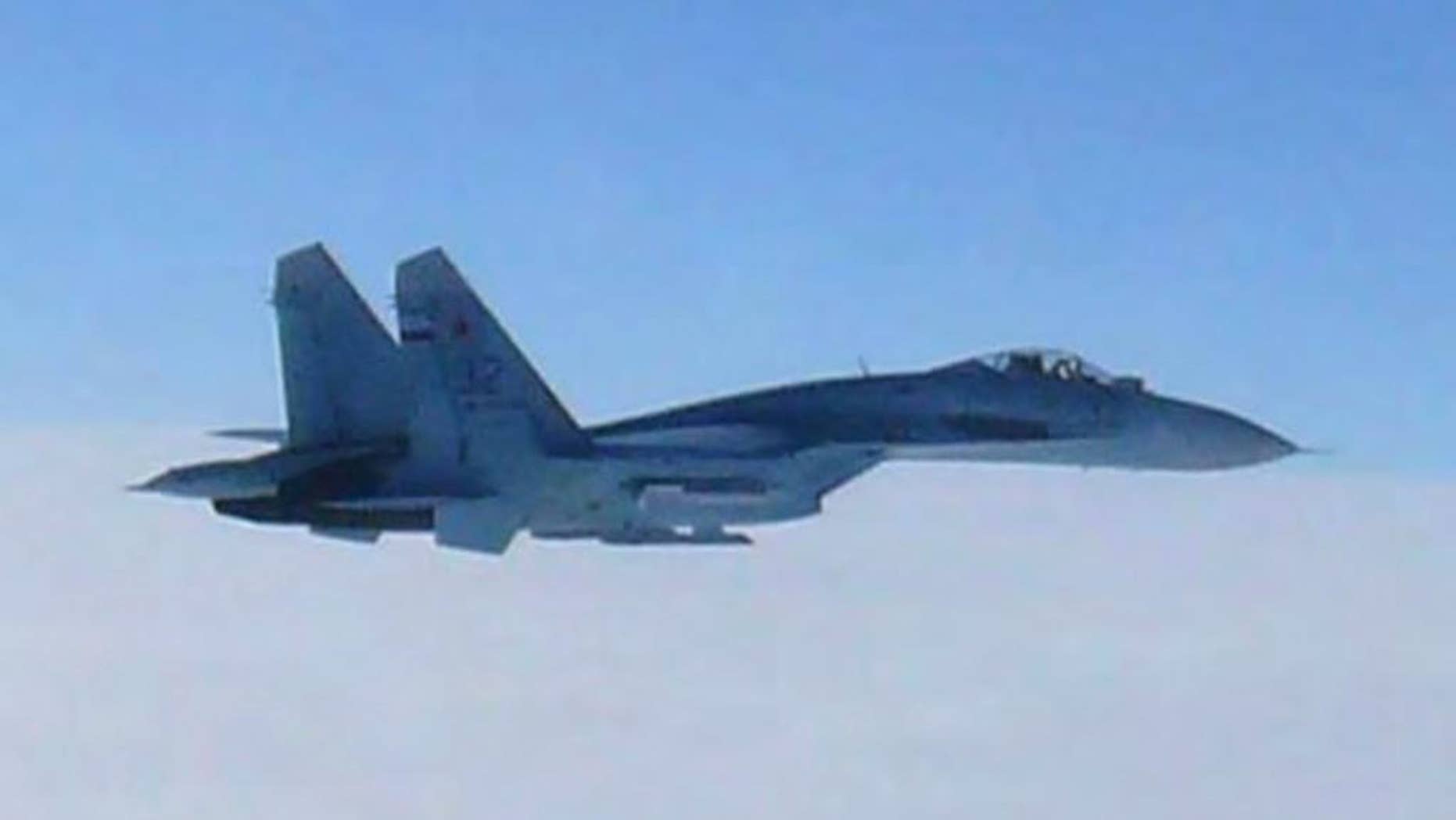 FILE - In this Feb. 7, 2013 file photo taken by Japan Air Self-Defense Force and released by the Joint Staff Office of the Defense Ministry of Japan, Russian fighter jet SU-27 flies over the sea off the Japanese island of Hokkaido when the Defense Ministry said two SU-27 jets, including the one shown in this photo, briefly intruded into Japanese airspace in the afternoon off the coast of Rishiri island on Hokkaido's west coast, prompting Japan’s air force to scramble jets. Japan's government said Wednesday, April 15, 2015 that the number of scrambles by the country's warplanes has surged in recent years to levels nearly matching the Cold War era amid growing activity by China and Russia in the region. (The Joint Staff Office of the Defense Ministry of Japan via AP, File)