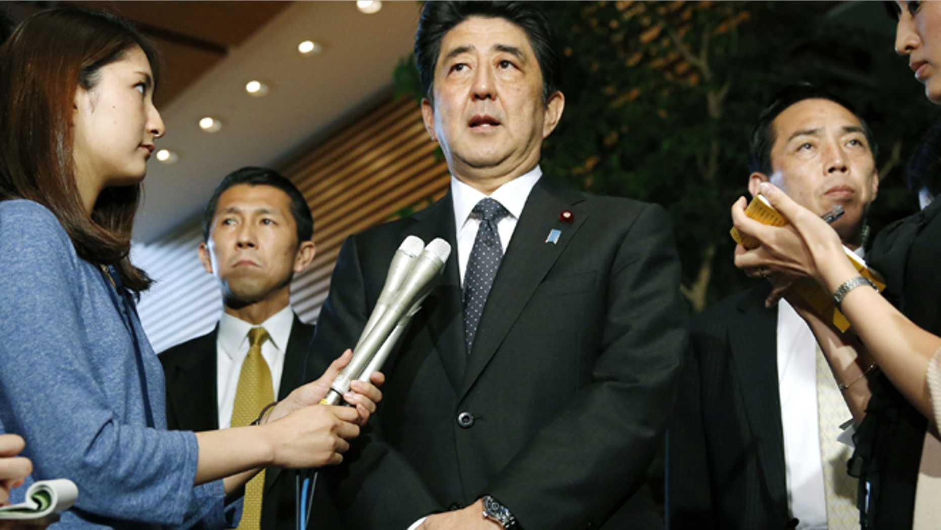 May 29. 2014: Japanese Prime Minister Shinzo Abe, center, speaks to the media about a three-day talks in Stockholm with North Korea at the prime minister's official residence in Tokyo. (AP)