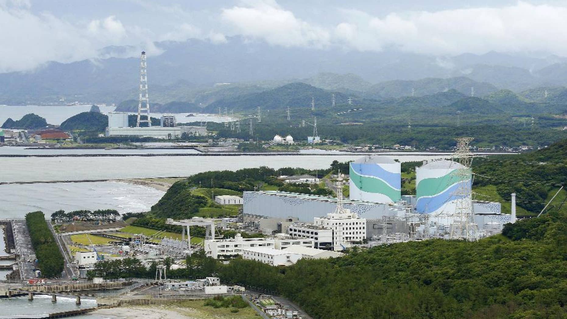 This June 2013 photo shows No. 1, right, and No. 2 at Sendai nuclear power station in Sendai, Kagoshima prefecture, southwestern Japan. A prominent volcanologist disputed Japanese regulators' conclusion that two nuclear reactors were safe from a volcanic eruption in the next few decades, saying Friday, Oct. 17, 2014 that such a prediction was impossible. A cauldron eruption at one of several volcanos surrounding the Sendai nuclear power plant could not only hit the reactors but could cause a nationwide disaster, said Toshitsugu Fujii, head of a government-commissioned panel on volcanic eruption prediction. (AP Photo/Kyodo News) JAPAN OUT, CREDIT MANDATORY