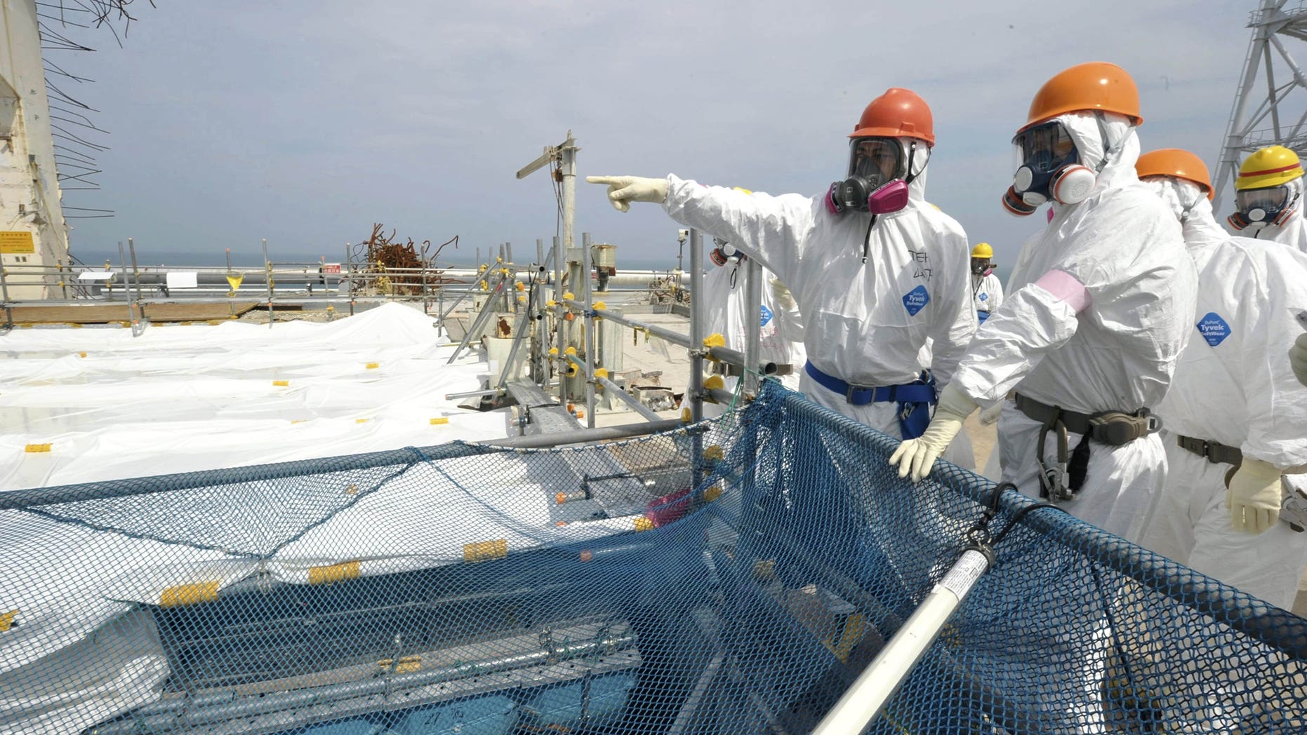 May 26, 2012: Japan's Environment and Nuclear Minister Goshi Hosono, second from left, inspects a pool containing spent fuel rods inside the No. 4 reactor building at Tokyo Electric Power Co. 's tsunami-crippled Fukushima Dai-ichi nuclear power plant in Okuma, Fukushima Prefecture, Japan, Saturday, May 26, 2012. The pool, located at the top of the building above the reactor, remains one of the plant's biggest risks due to its vulnerability to earthquakes. (AP Photo/Toshiaki Shimizu, Japan Pool) JAPAN OUT