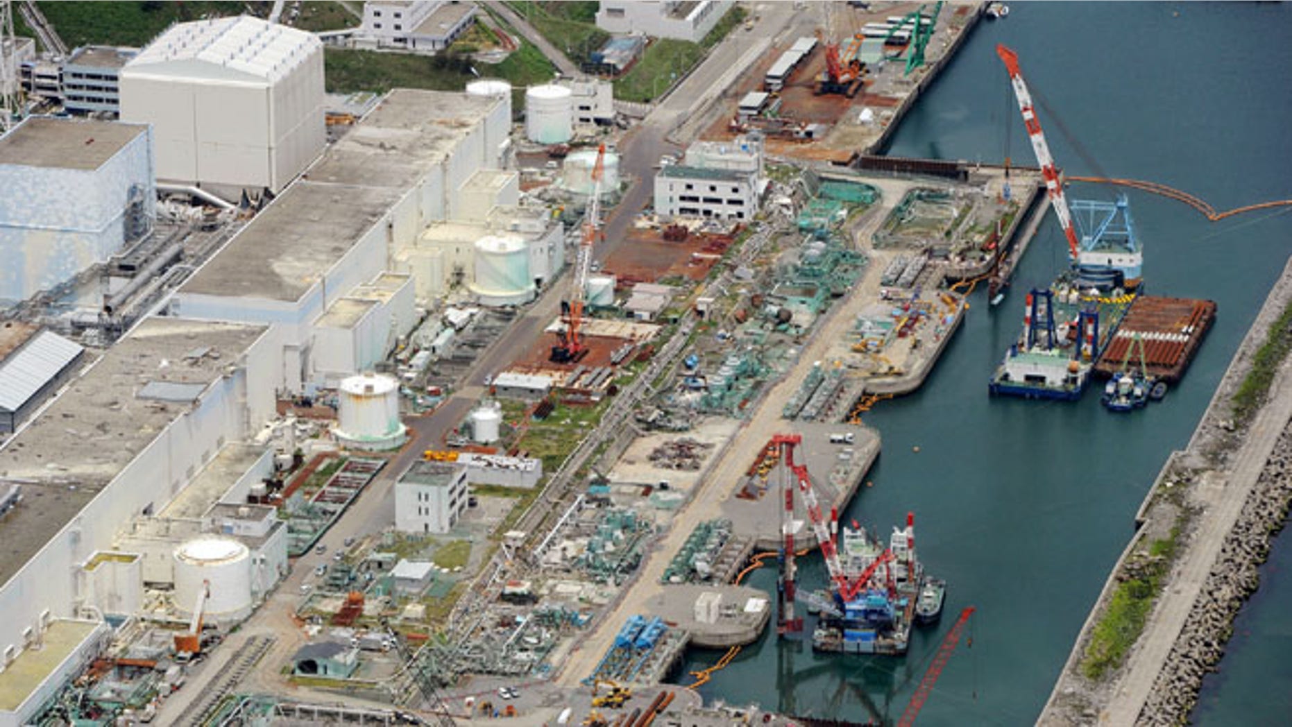 July 9, 2013: This aerial photo taken on shows reactor buildings Unit 2, left, and Unit 1 at Fukushima Dai-ichi nuclear power plant in Okuama, Fukushima Prefecture, northern Japan.