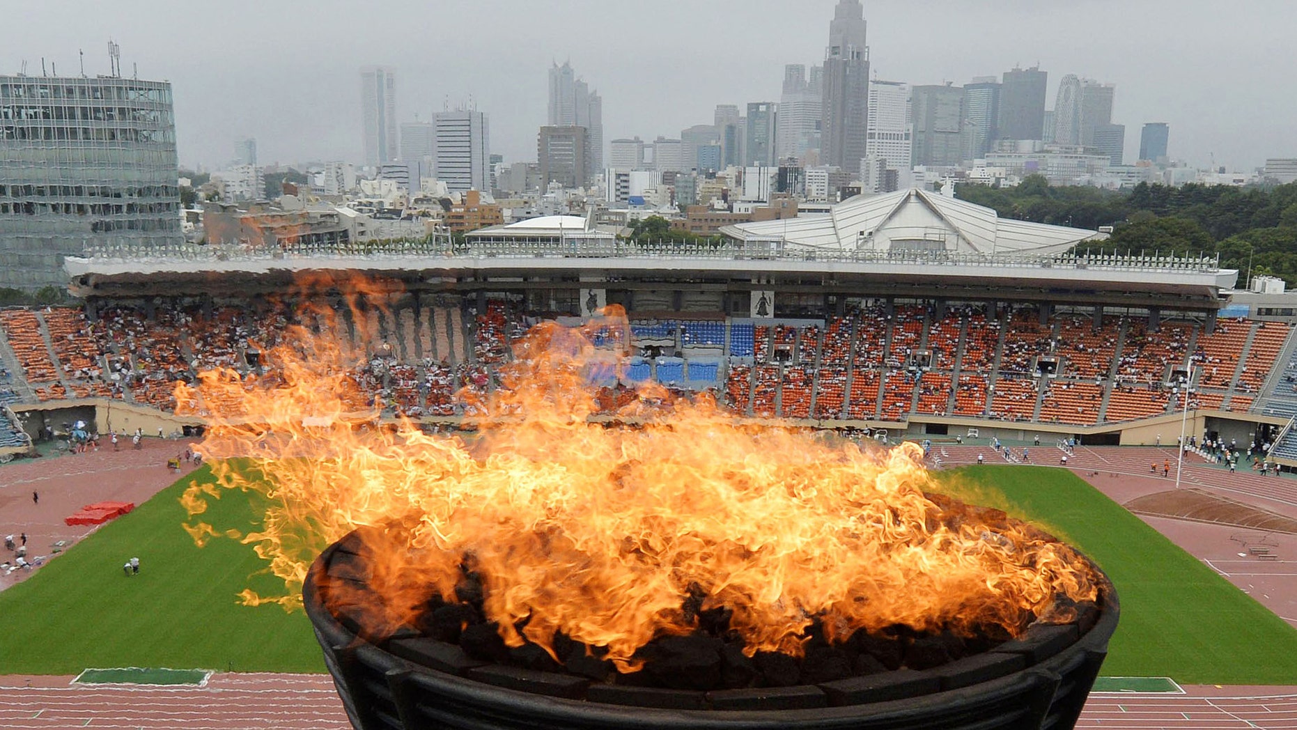 A flame is ignited at the Olympic cauldron at National Stadium in Tokyo to celebrate the city's successful bid to host the 2020 Olympics, Sunday, Sept. 8, 2013. (AP Photo/Kyodo News)