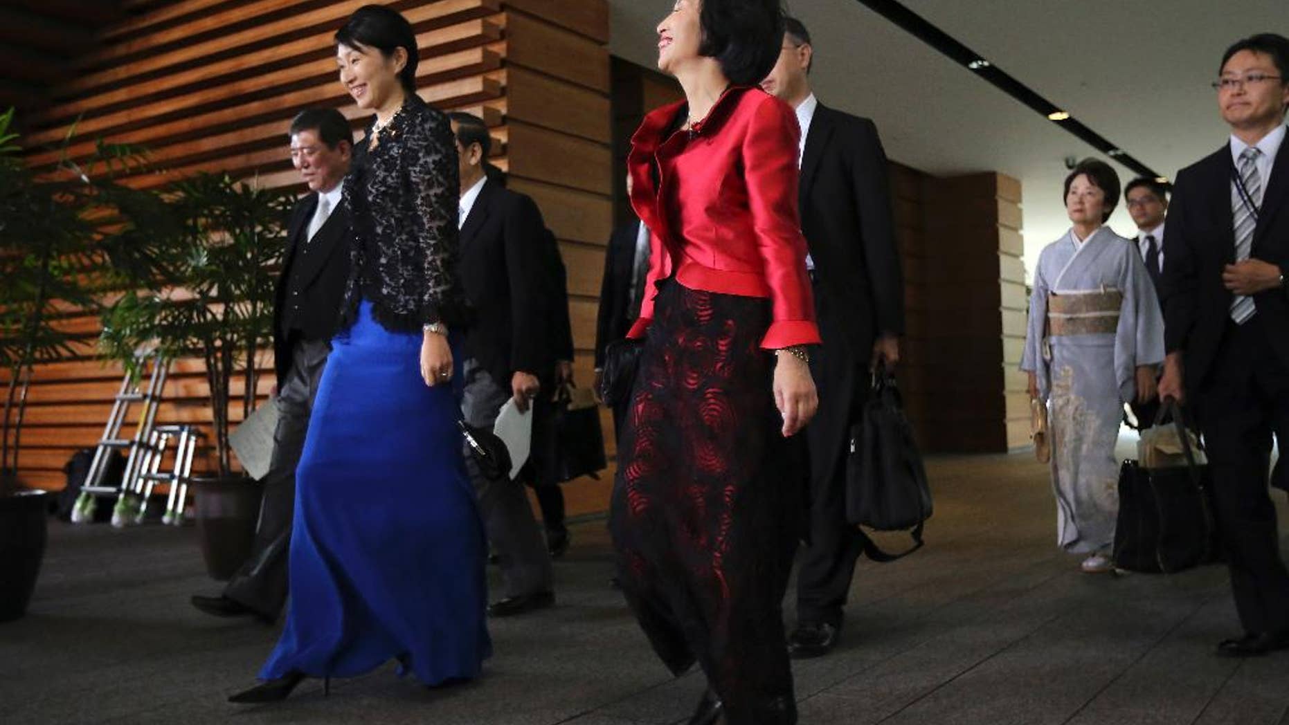 Midori Matsushima, center, newly appointed minister of Justice, Yuko Obuchi, 2nd left, newly appointed minister of Trade and Economy, and Eriko Yamatani, 3rd right, newly appointed minister in charge of abduction issue, leave for the attestation ceremony at the Imperial Palace at the prime minister's official residence in Tokyo Wednesday, Sept. 3, 2014. (AP Photo/Eugene Hoshiko)