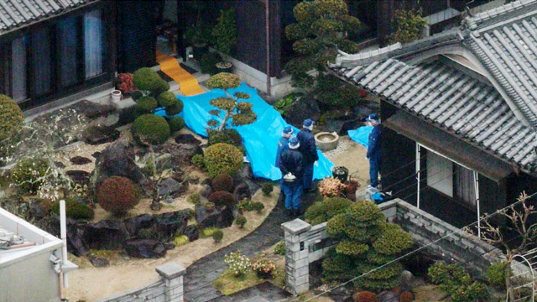 March 9, 2015: Police inspect a house where a stabbing murder took place in Sumoto, Hyogo prefecture. Police say five people have been killed in a stabbing spree in a small town in western Japan. A 40-year-old man has been arrested in connection with the Monday morning attacks.(AP Photo/Kyodo ews)