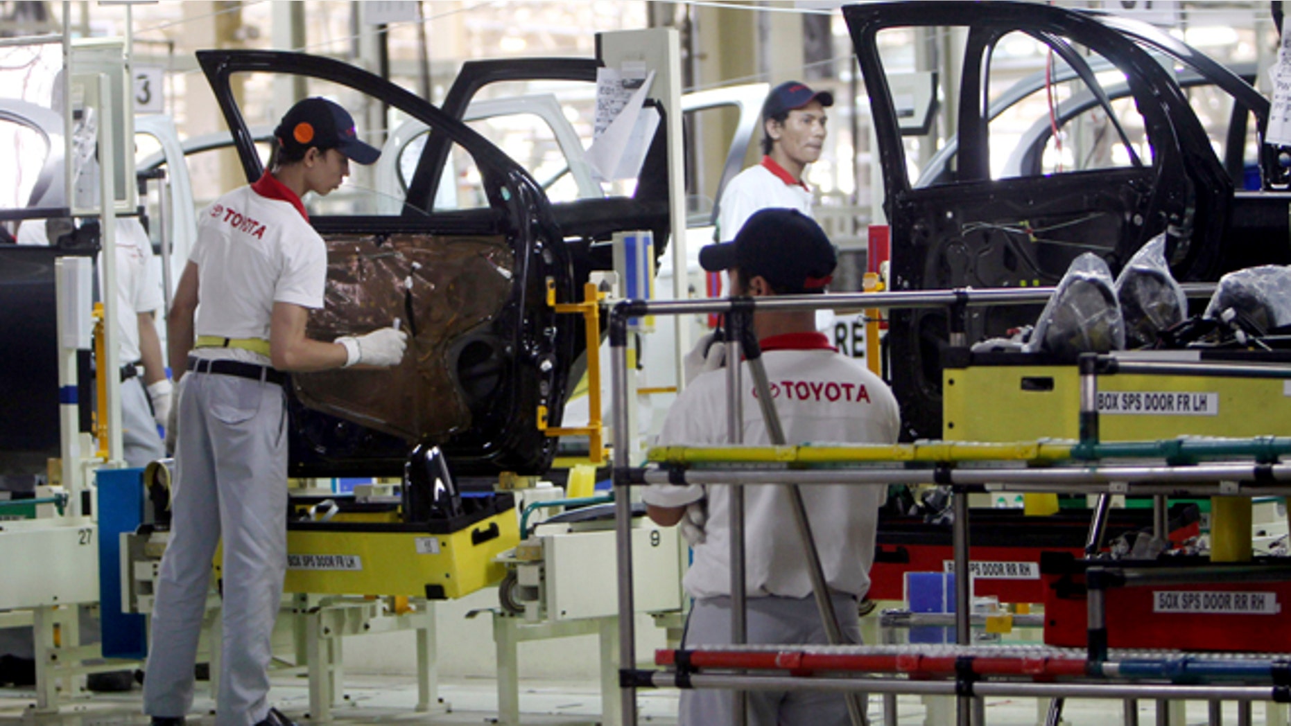 FILE - In this March 15, 2013 file photo, Indonesian workers assemble passenger cars at the new Toyota plant in Karawang, West Java, Indonesia after Toyota officially opened their second manufacturing plant in the country. Toyota is building two new auto plants, one in Mexico and the other in China, ending a three-year hiatus from such ambitions that the Japanese automaker voluntarily imposed on itself after a massive recall scandal. Toyota Motor Corp. announced Wednesday, April 15, 2015 it will invest $1 billion for the plant in Guanajuato, Mexico, creating 2,000 jobs, to make the Corolla subcompact - one of Toyotaâs biggest hits. (AP Photo/Tatan Syuflana, File)