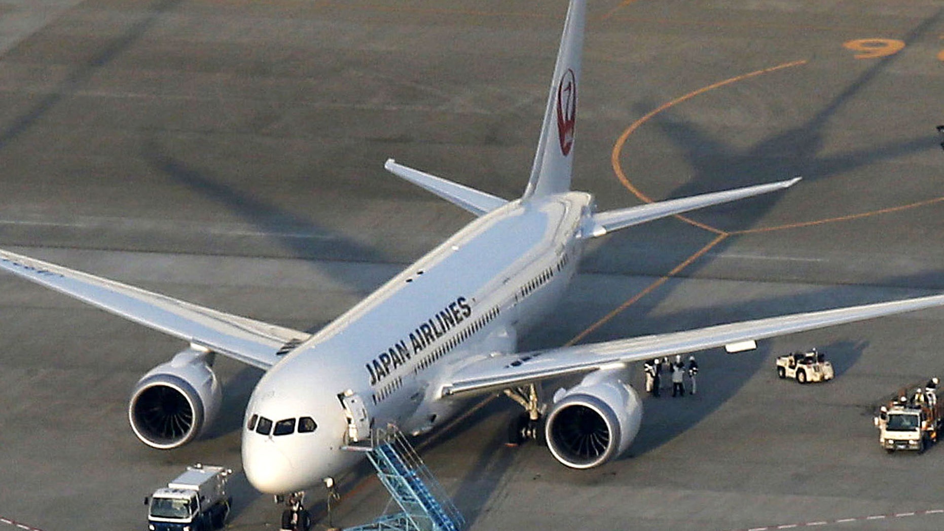 A Japan Airlines 787, from which fuel spilled at Boston's Logan International Airport last Tuesday, sits on the tarmac at Narita Airport in Narita, east of Tokyo, Sunday, Jan. 13, 2012. Narita airport officials said JAL reported a 100-liter fuel leak from a filler on the 787 during inspection following recent spate of problems. (AP Photo/Kyodo News) JAPAN OUT, MANDATORY CREDIT, NO LICENSING IN CHINA, HONG KONG, JAPAN, SOUTH KOREA AND FRANCE