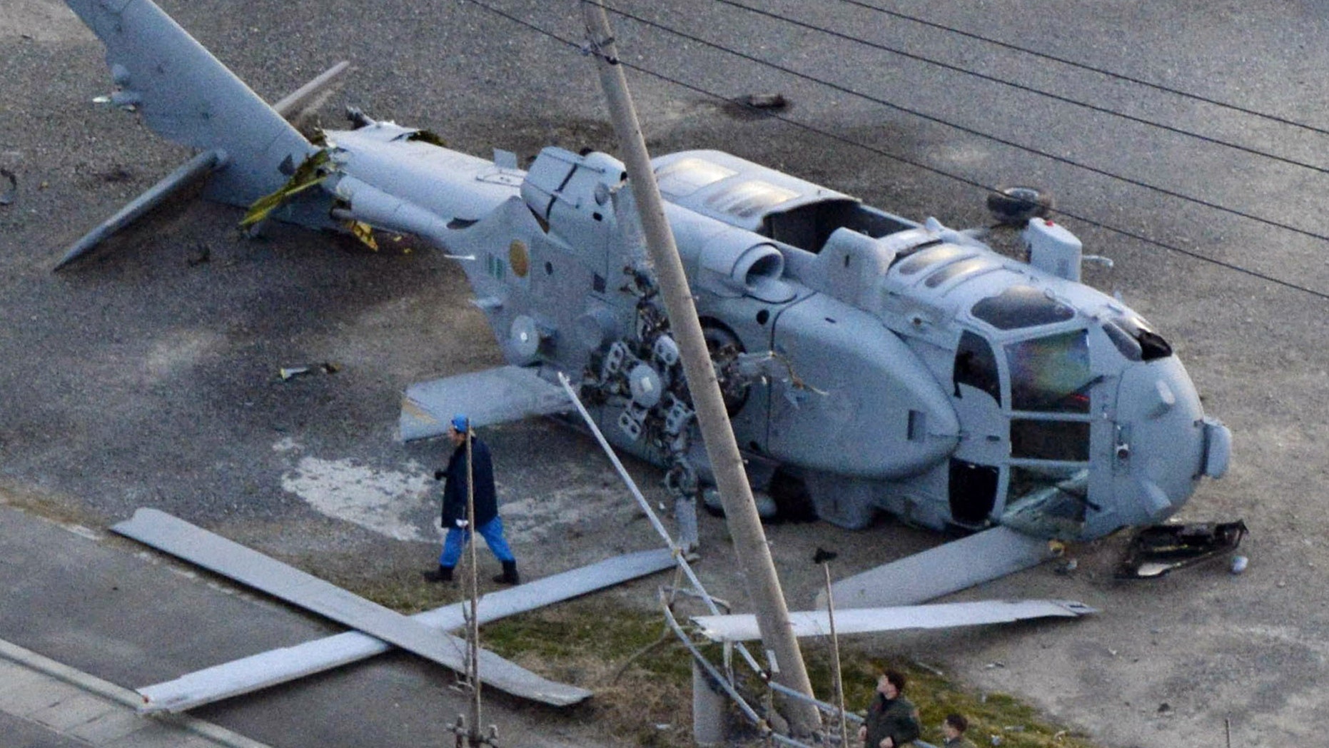 Dec. 16, 2013 - A U.S. Navy MH-60 helicopter lies on the ground after making an emergency landing in Miura city, near Tokyo. U.S. Forces Japan spokesman David Honchul said 2 injured crew members from the helicopter were taken to a hospital for treatment. (courtesy Kyodo News)