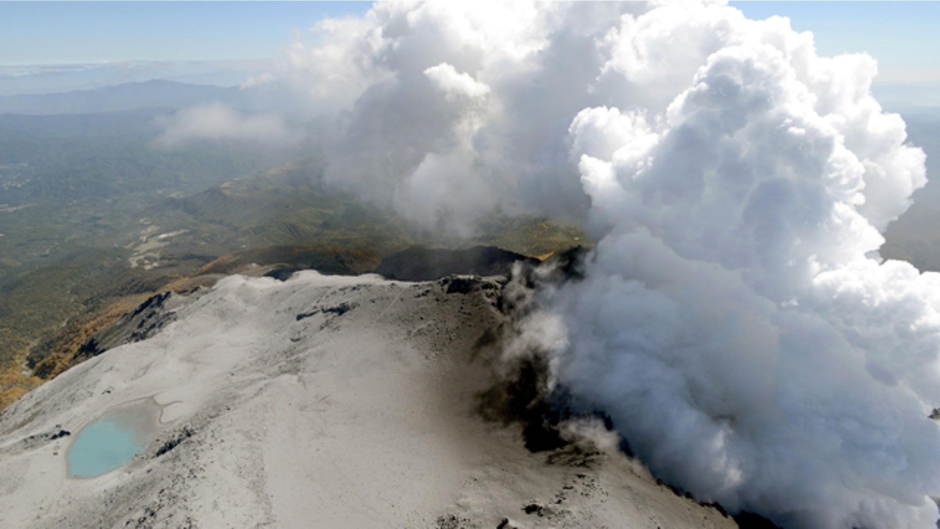 September 30, 2014: An aerial view shows volcanic smoke and fumes rising from the craters of Mount Ontake, central Japan. (AP Photo/Kyodo News)