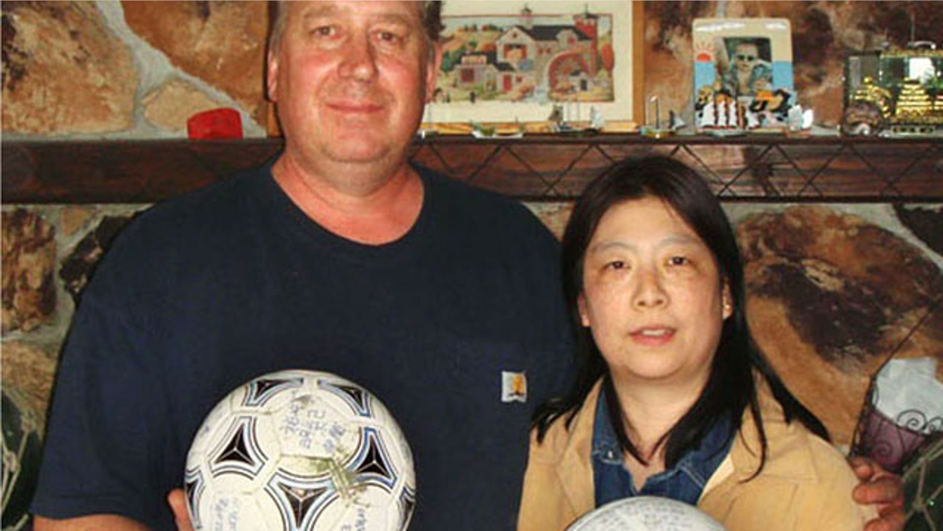 April 21, 2012: David and Yumi Baxter hold a soccer ball and a volleyball which David found, at their house in the suburbs of Anchorage, Alaska