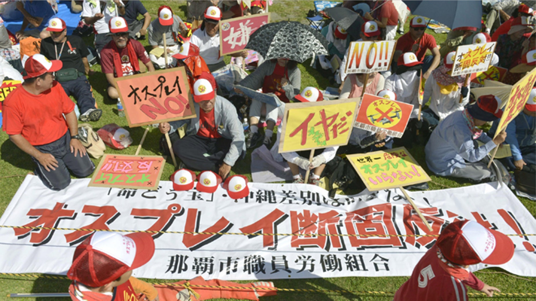 Sept. 9, 2012: Participants display banners against a planned deployment of Osprey aircraft during a rally in Ginowan, on the southern island of Okinawa, Japan.
