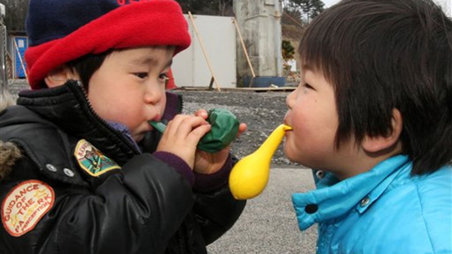 March 21, 2011: Children play with balloons at a shelter in the March 11 earthquake and tsunami-destroyed town of Minamisanriku, northern Japan.