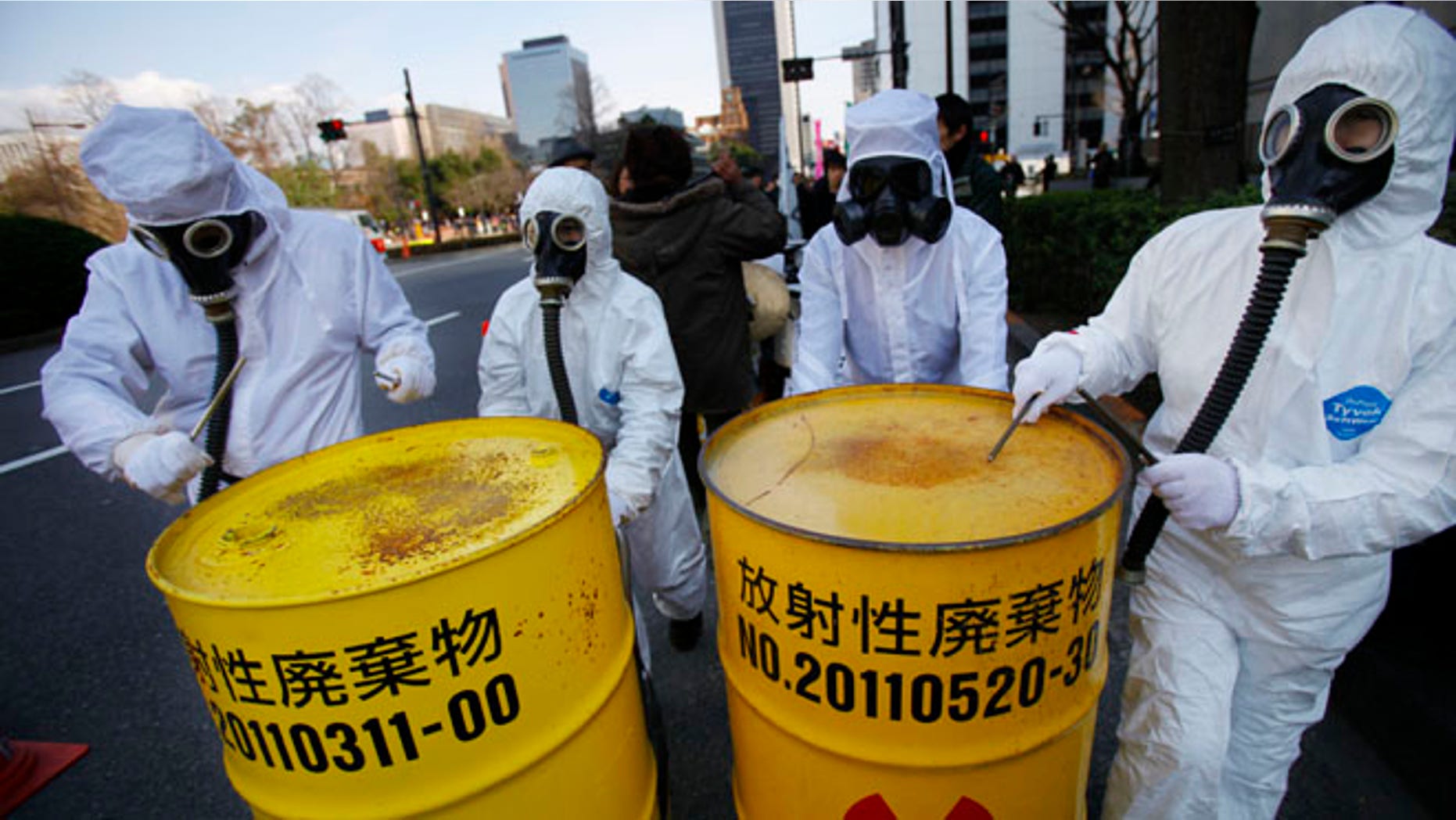 March 9, 2014: Costumed protesters beat drum cans during an anti-nuclear plant demonstration in Tokyo.