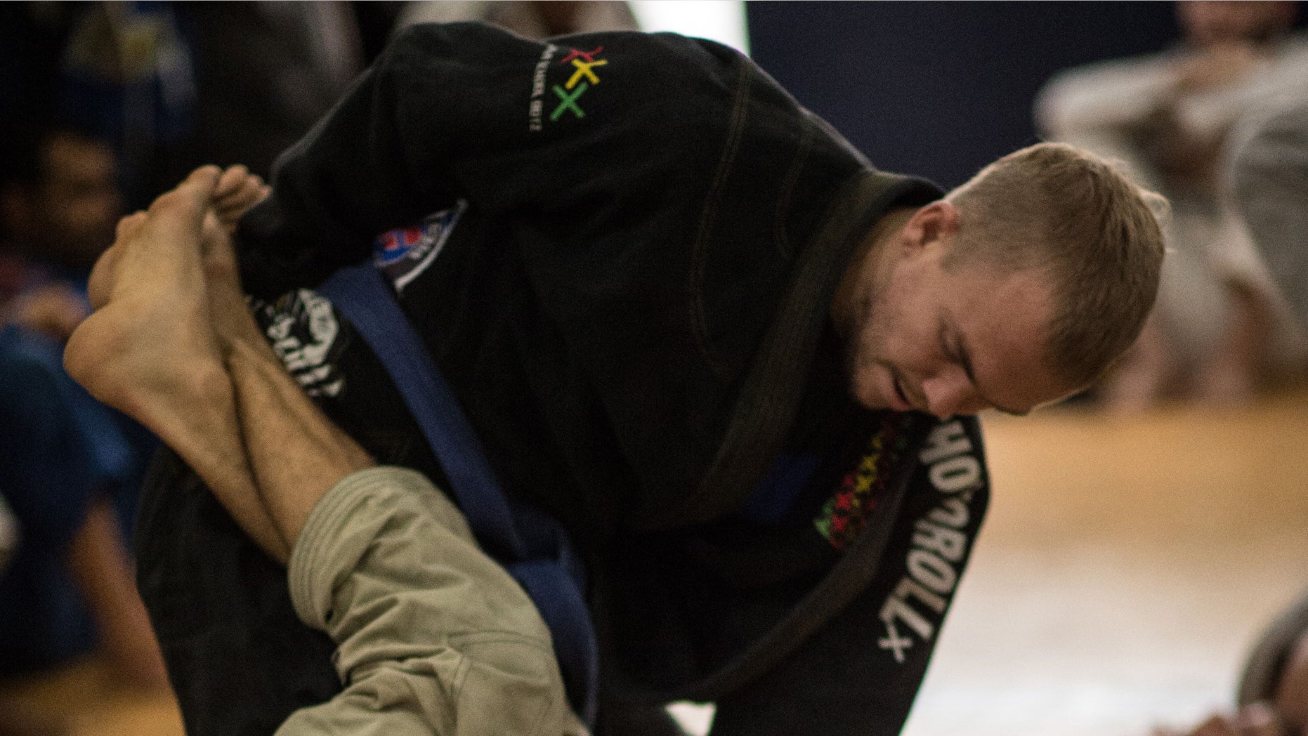 TO GO WITH AFP STORY by Sebastian SmithNew Zealander Jason Lee (top) practices jiu-jitsu in Rio de Janeiro, Brazil, on September 14, 2015. Once restricted almost entirely to the Latin American country, Brazilian jiu-jitsu is one of the world's fastest-growing forms of unarmed combat, credited with igniting the mixed martial arts or MMA cage fighting phenomenon, and popular from the United States to the Middle East and Asia. AFP PHOTO / CHRISTOPHE SIMON (Photo credit should read CHRISTOPHE SIMON/AFP/Getty Images)