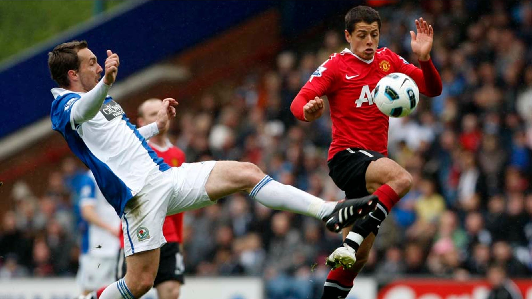 Manchester United's Javier Hernandez, right, vies for the ball against Blackburn's Gael Givet during their English Premier League soccer match at Ewood Park, Blackburn, England, Saturday May 14, 2011. (AP Photo/Tim Hales) NO INTERNET/MOBILE USAGE WITHOUT FOOTBALL ASSOCIATION PREMIER LEAGUE (FAPL) LICENCE. CALL +44 (0) 20 7864 9121 or EMAIL info@football-dataco.com FOR DETAILS