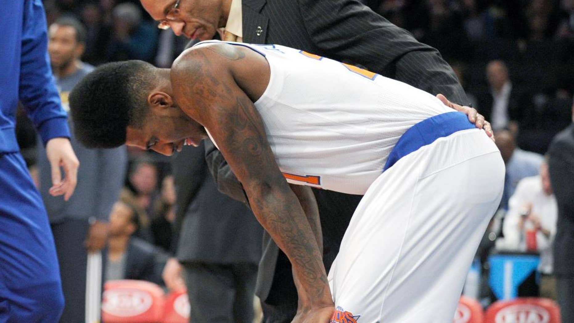 New York Knicks' Iman Shumpert reacts after being injured during the first quarter of an NBA basketball game against the Utah Jazz Friday, Nov. 14, 2014, at Madison Square Garden in New York. (AP Photo/Bill Kostroun)