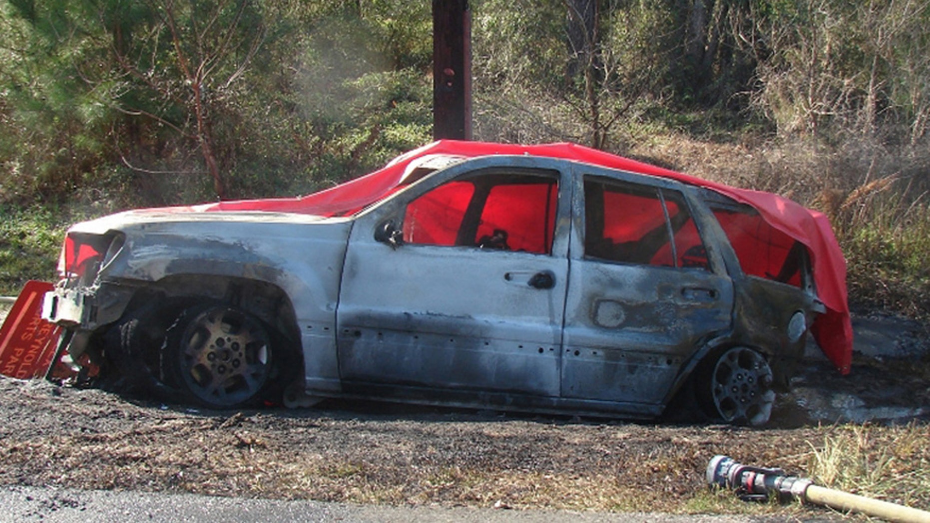 FILE - This March 6, 2012 file photo provided by the law offices of Butler, Wooten & Fryhofer, LLP shows the scene of a crash in Bainbridge, Ga. On April 2, 2015, a Georgia jury awarded $150 million to the family of Remington "Remi" Walden, a 4-year-old boy killed when a Jeep Grand Cherokee exploded into flames three years ago after being rear-ended. Nearly two years after agreeing to recall 1.56 million older Jeeps that could catch fire in rear-end crashes, Fiat Chrysler U.S. has repaired only 4 percent of the Grand Cherokees and 27 percent of the Libertys covered by the recall, according to documents filed with federal safety regulators. The repair rate is far below the average of 75 percent 1 ½ years after a recall is announced, and it could set up another confrontation between Chrysler, which makes Jeeps, and the government. (Courtesy of Butler, Wooten & Fryhofer, LLP via AP, File)