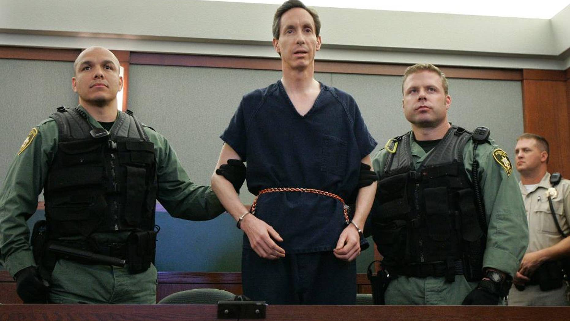 FILE - In this Aug. 31, 2006, file photo, polygamous church leader Warren Jeffs appears in a courtroom surrounded by guards, in Las Vegas. The red Cadillac Escalade used by Jeffs when he tried to flee authorities will be for sale in St. George. The Spectrum reports that the Escalade and the credit cards, gift cards and other items found inside it will be auctioned off. (AP Photo/Laura Rauch, File)