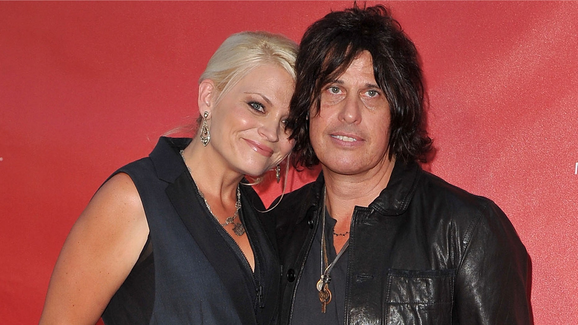 Jenn DeLeo claims husband Dean began abusing drugs and alcohol shortly after she gave birth to their daughter in 2012. The photo above shows the couple arriving at the 9th Annual MusiCares MAP Fund Benefit Concert on May 30, 2013 in Los Angeles.