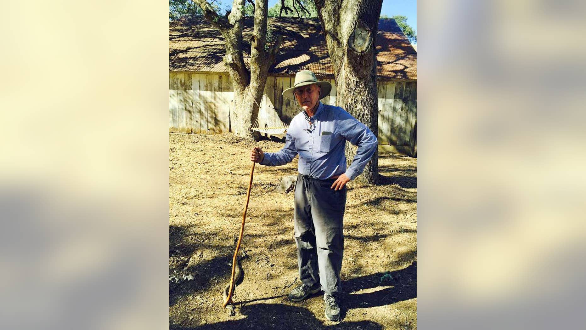 In this undated photo taken by California first lady Anne Gust and posted to Gov. Jerry Brown's Twitter account on Saturday, April 18, 2015, California Gov. Jerry Brown poses with a rattlesnake, held with a snake stick, on land Brown’s family owns in rural Colusa county, near Williams, Calif. (Anne Gust via AP)
