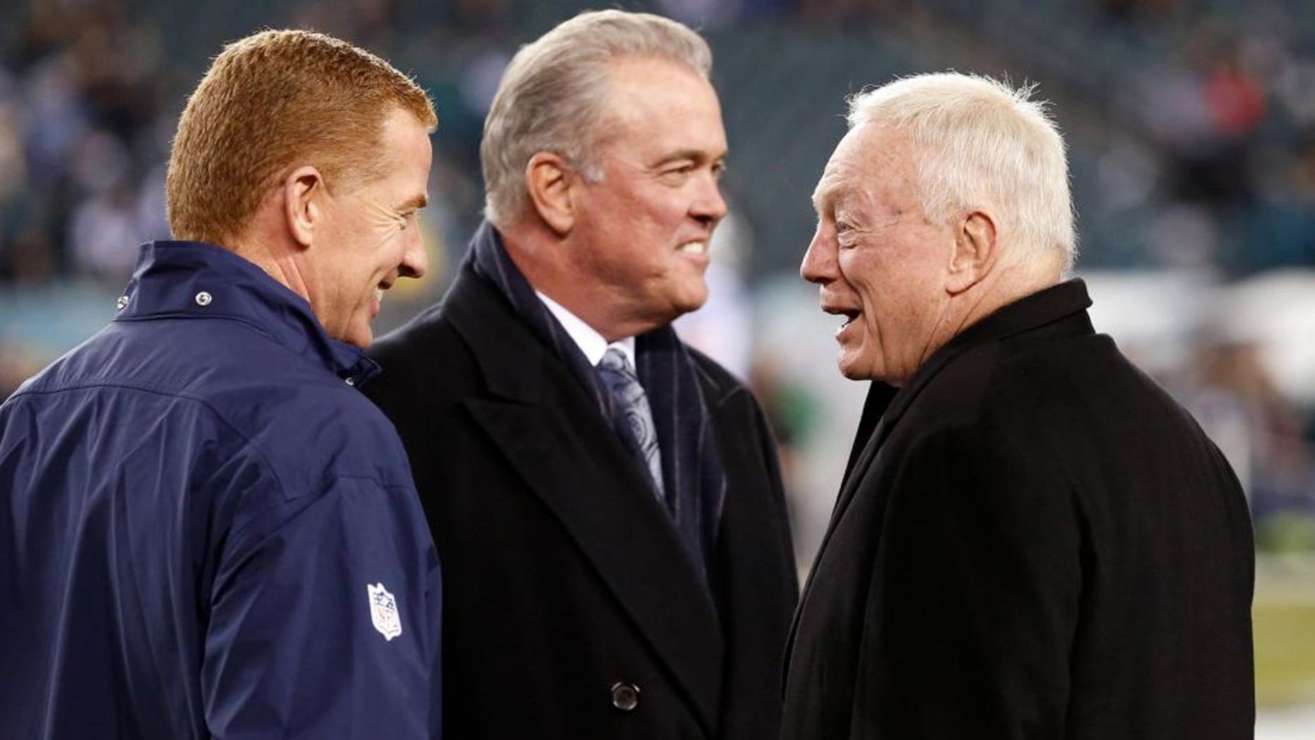 Dec 14, 2014; Philadelphia, PA, USA; Dallas Cowboys head coach Jason Garrett (left) and owner Jerry Jones (right) talk during warm ups before a game against the Philadelphia Eagles at Lincoln Financial Field. Mandatory Credit: Bill Streicher-USA TODAY Sports