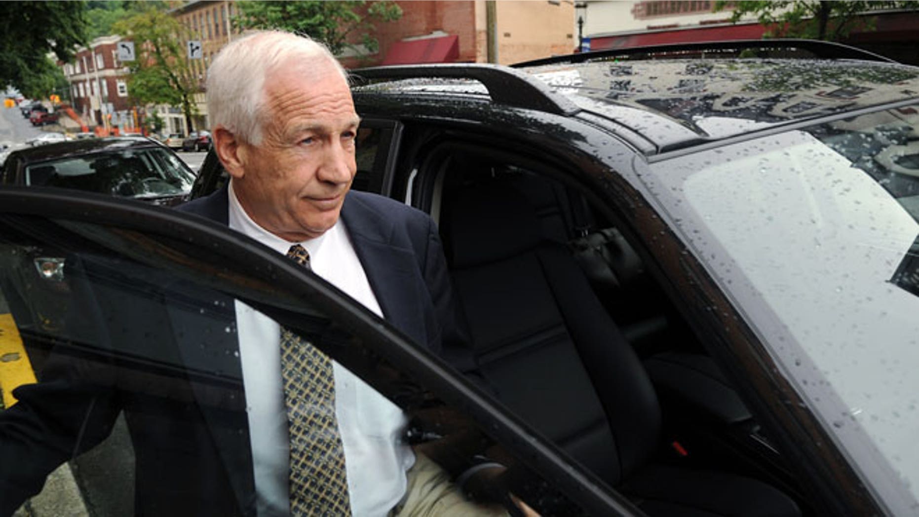 In a Tuesday, May 29, 2012 file photo, Jerry Sandusky gets into his attorney Joe Amendola's car near the Centre County Courthouse Annex in Bellefonte, Pa.