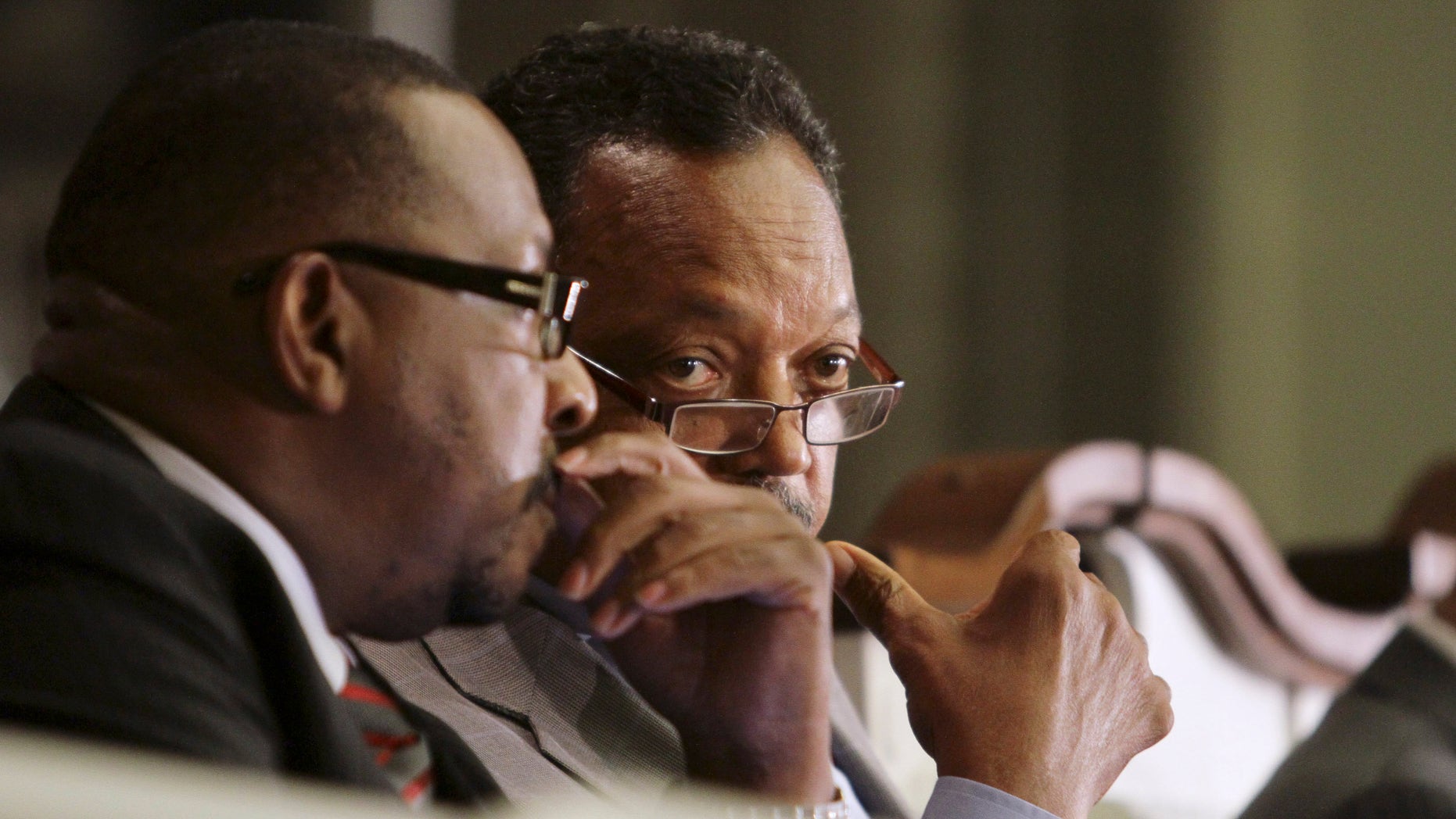 August 22: Bishop Victor T. Curry, left, and Rev. Jesse Jackson talk during a town hall meeting in Miami. The Congressional Black Caucus organized the meeting to address black unemployment rates, one of five taking place in August in distressed communities across the country. At issue is the stubbornly high unemployment rate in the black community, now at 16.8 percent nationwide, more than double that for whites.