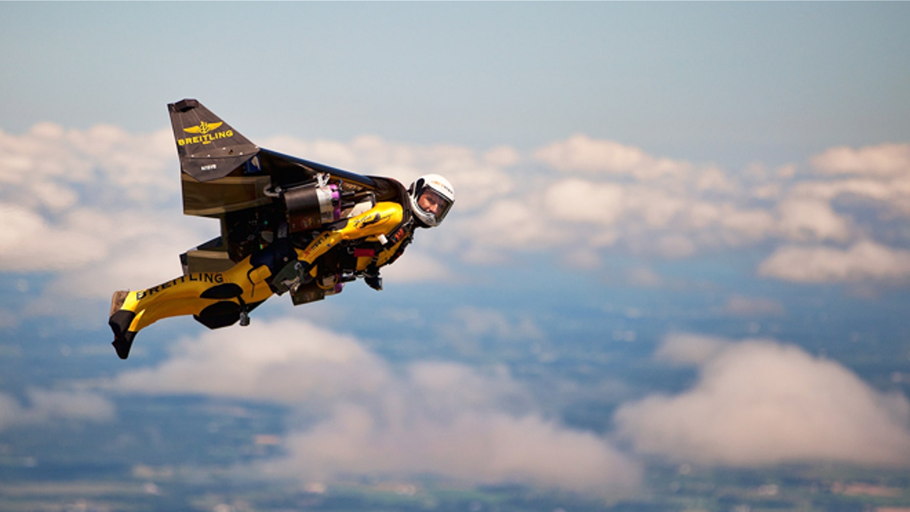 July 29, 2013: Swiss adventurer Yves Rossy, also known as "Jetman," flies in his carbon-Kevlar jetwing with four engines for during an event for reporters over Appleton, Wis.