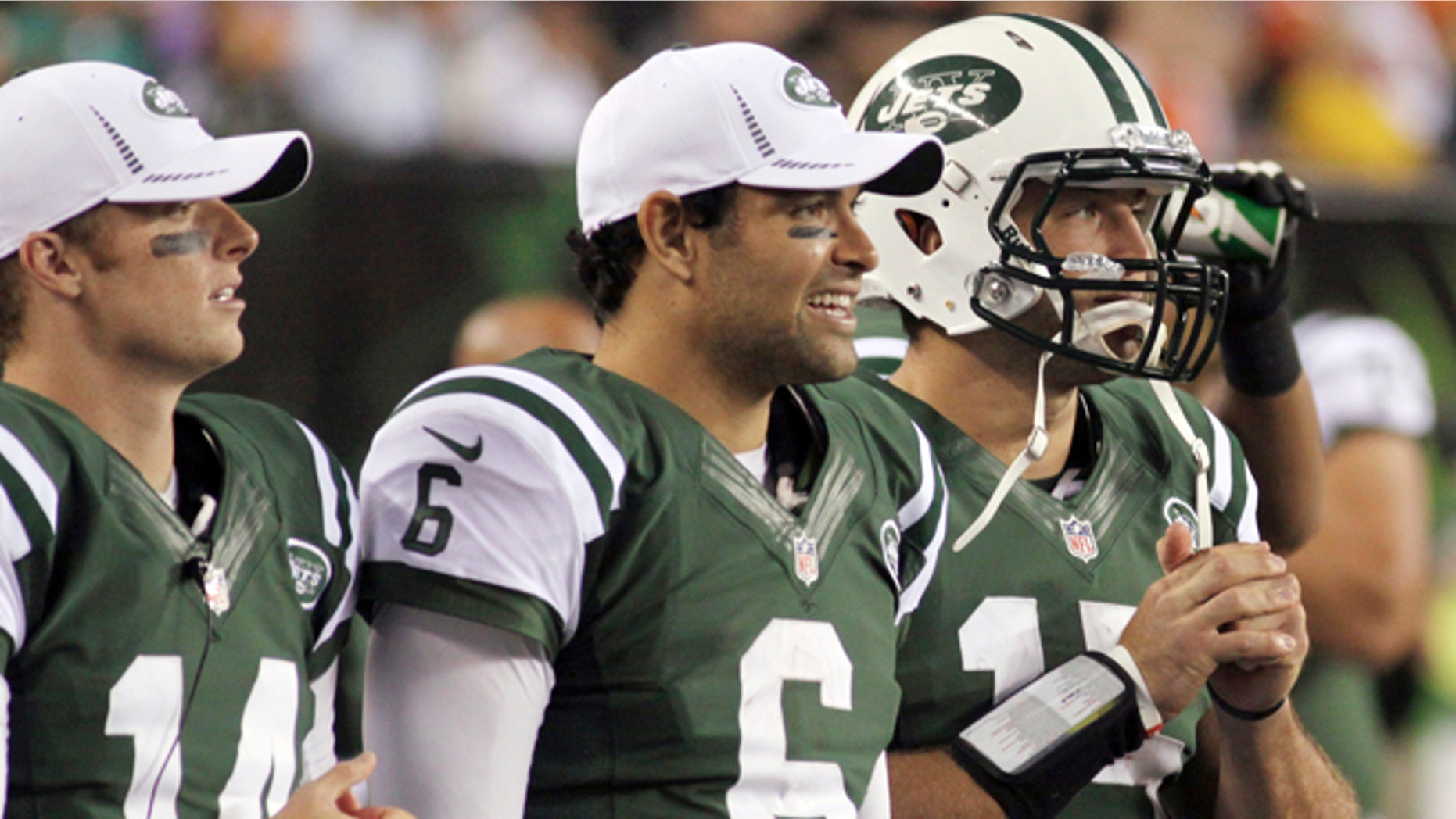 FILE - In this Aug. 10, 2012, file photo, New York Jets quarterbacks, from left, Greg McElroy, Mark Sanchez and Tim Tebow watch from the sidelines during the first half of a preseason NFL football game against the Cincinnati Bengals in Cincinnati. Jets coach Rex Ryan gathered his three quarterbacks Wednesday morning and told them he had made up his mind. It will be Sanchez and not McElroy orTebow on Sunday when the Jets take on the Jaguars in Jacksonville.(AP Photo/Tom Uhlman, File)