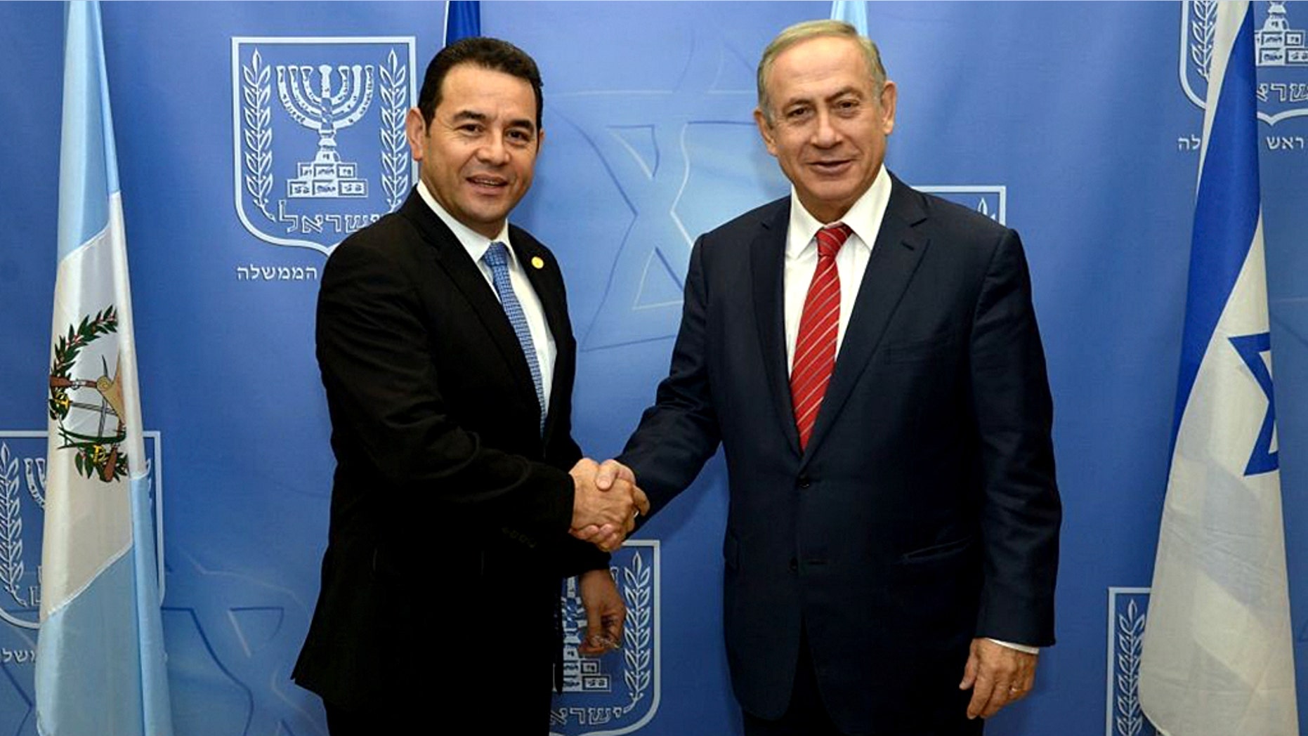 Guatemalan President Jimmy Morales and Israeli Prime Minister Benjamin Netanyahu shake hands at the opening of the Central American nation's embassy in Jerusalem.