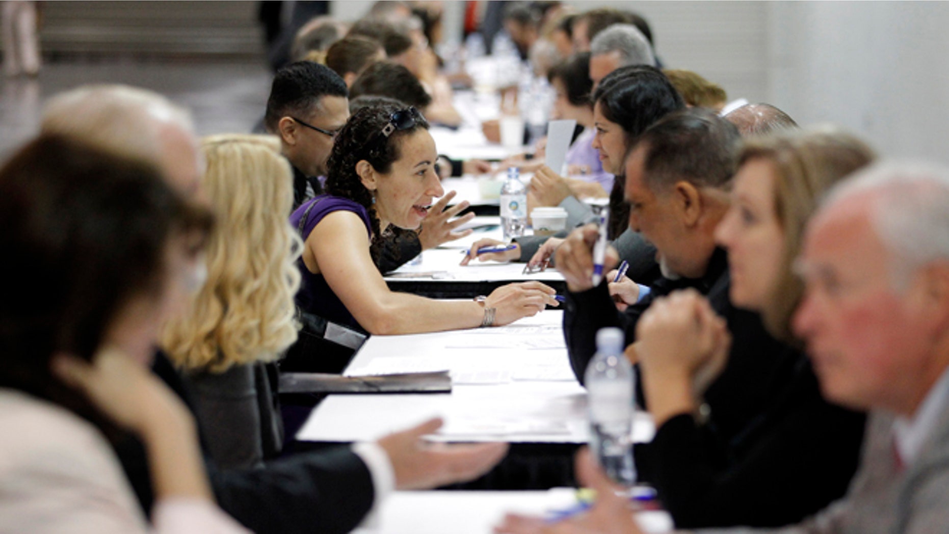 June 13, 2012: Job seekers have their resumes reviewed at a job fair expo in Anaheim, Calif.