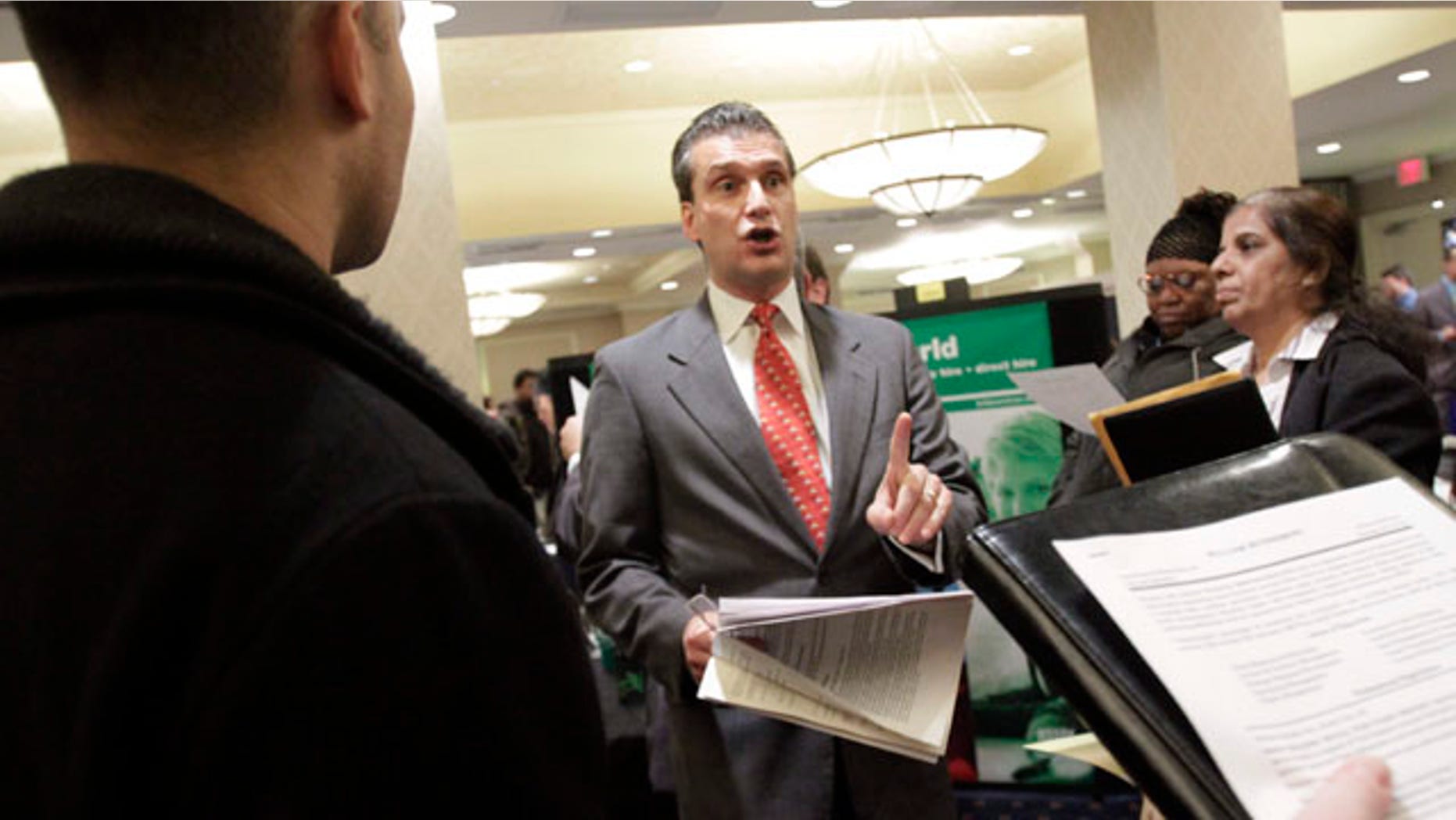 Nov. 9: A recruiter, center, speaks to job applicants during a job fair at the The Radisson Martinique hotel in New York.