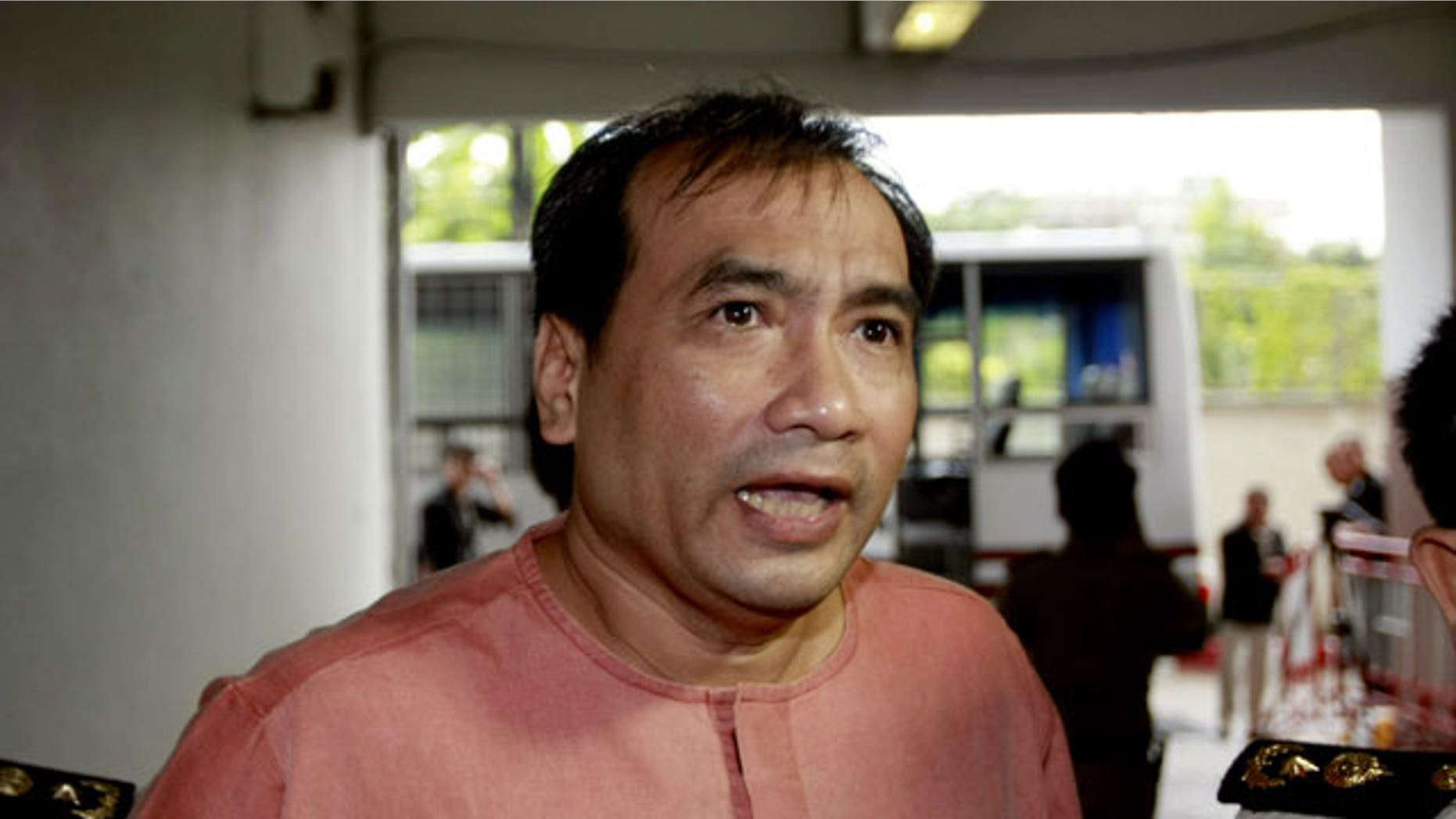 October 10, 2011: Joe Gordon, a Thai-born American, speaks to reporters upon his arrival at criminal court in Bangkok.