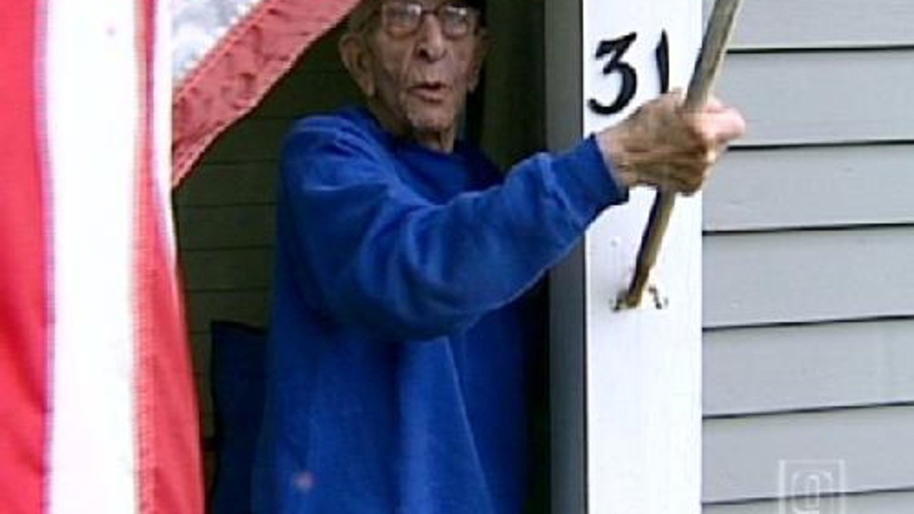 Joe LeVangie displays his flag outside his Hillborough, N.H. home.