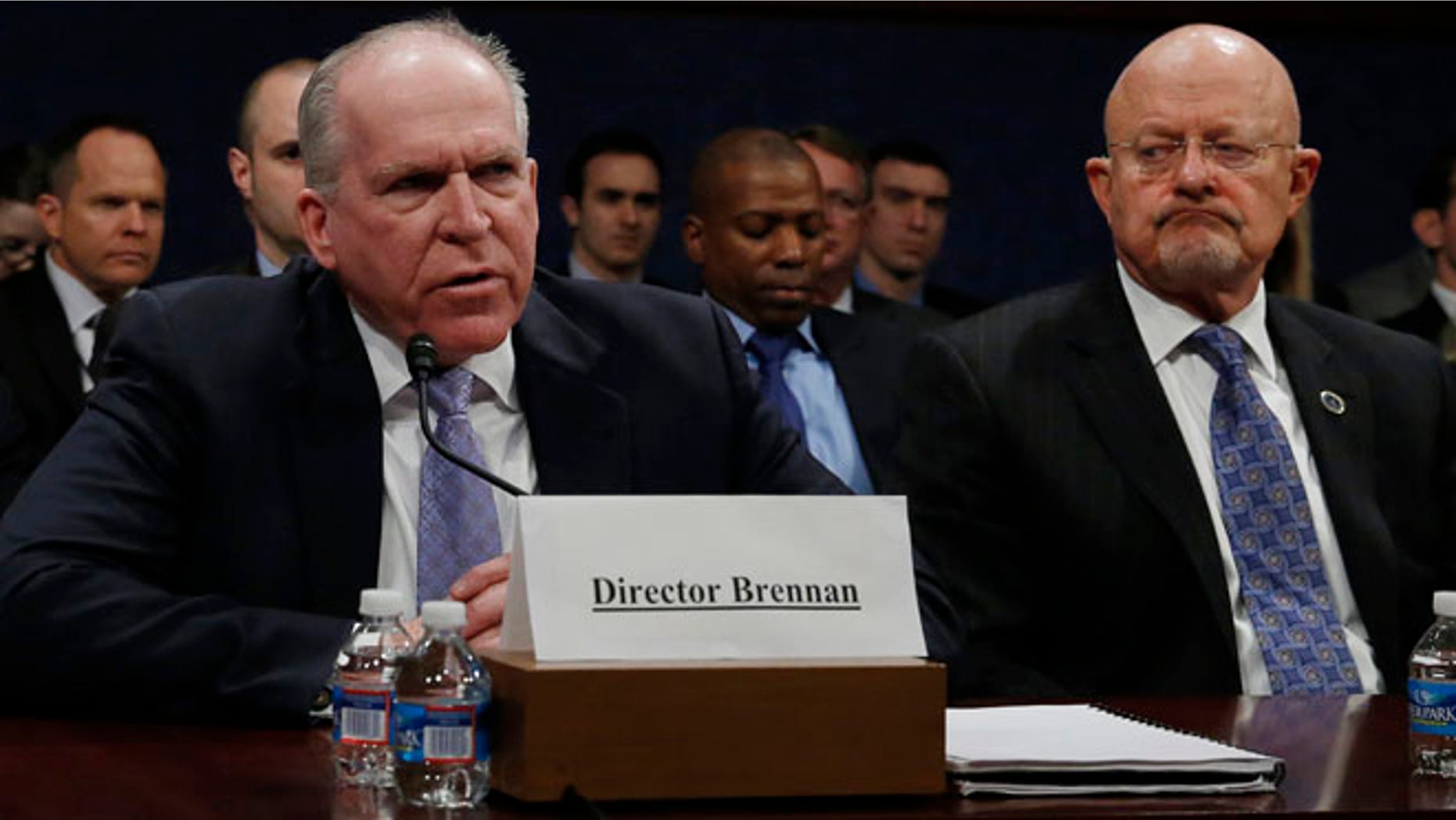 Director of U.S. National Intelligence James Clapper (R) listens to CIA Director John Brennan (L) during testimony at the House Intelligence Committee on 'Worldwide Threats', in Washington February 4, 2014.