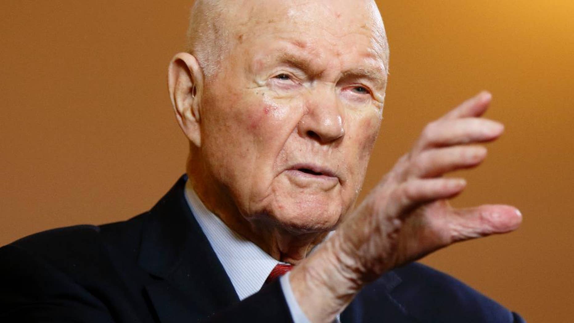 In this photo taken on Thursday, May 14, 2015, former astronaut and senator John Glenn gestures while answering questions during an exclusive interview with The Associated Press at the Ohio Statehouse. Glenn said facts about scientific discovery should be taught in schools - and that includes evolution. The 93-year-old said that he sees no contradiction between believing in God and believing in evolution. When he went back into space in 1998, he had announced that "to look out at this kind of creation out here and not believe in God is to me impossible.” (AP Photo/Paul Vernon)