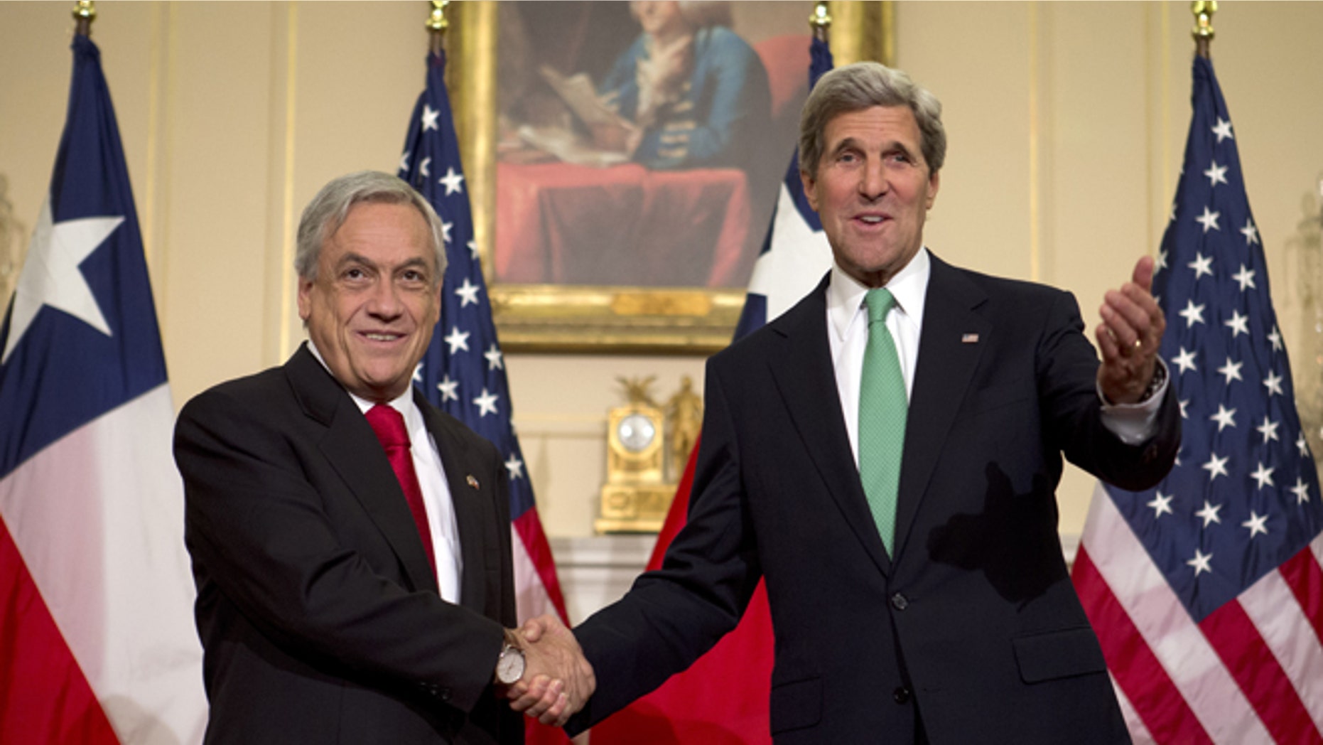 Secretary of State John Kerry gestures as he shakes hands with Chile's President Sebastian Pinera during a short appearance before the media, Monday, June 3, 2013, at the State Department in Washington. (AP Photo/Jacquelyn Martin)