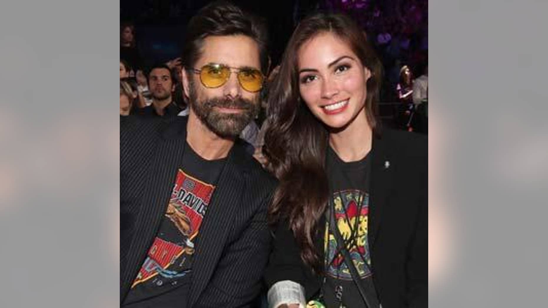 John Stamos poses with fiancee Caitlin McHugh.