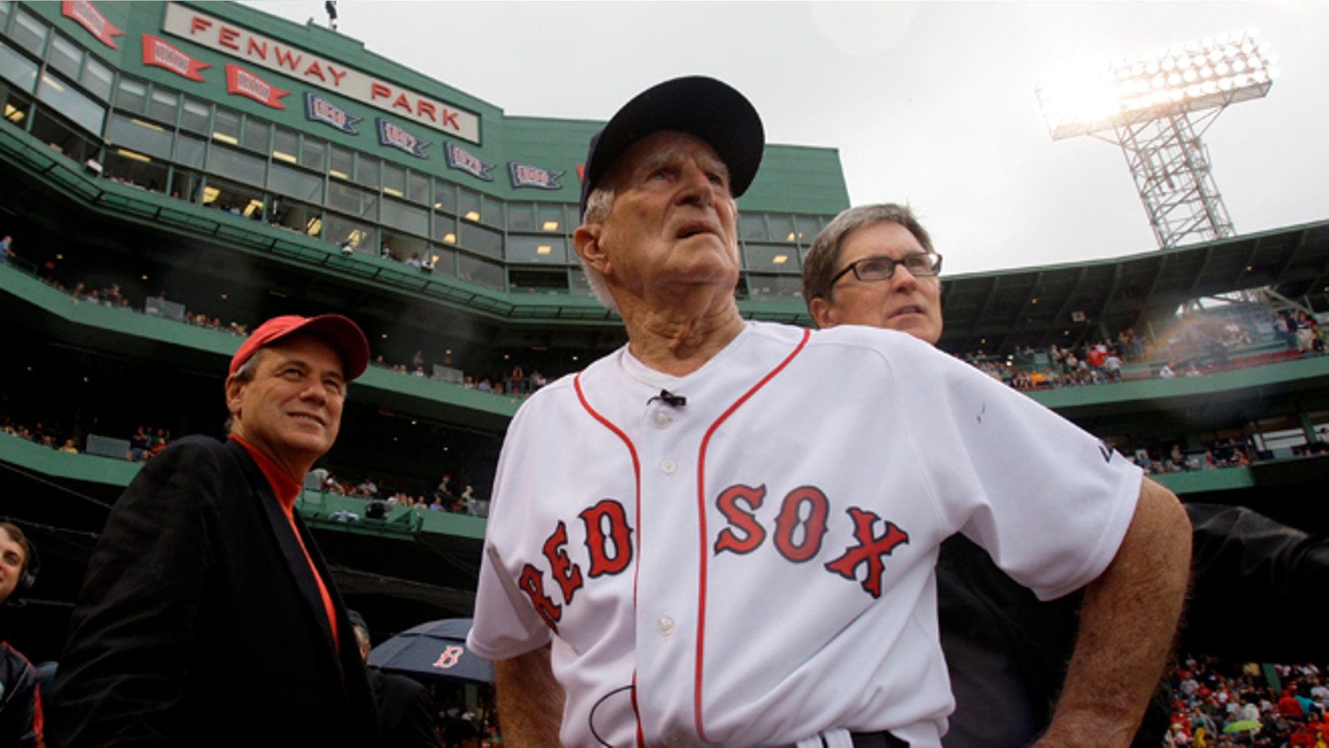 Sept. 28, 2008: Boston Red Sox great Johnny Pesky, center, is flanked by team president Larry Lucchino, left, and owner John Henry as they look past Pesky's Pole where Pesky's No. 6 adorns the upper deck during a ceremony to retire his number.