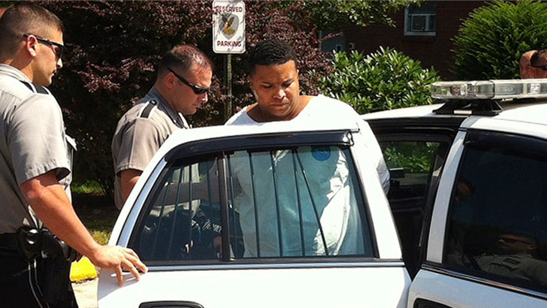 Aug. 12, 2013: Daniel Rodriguez is put into a squad car outside police headquarters in Johnston, R.I.