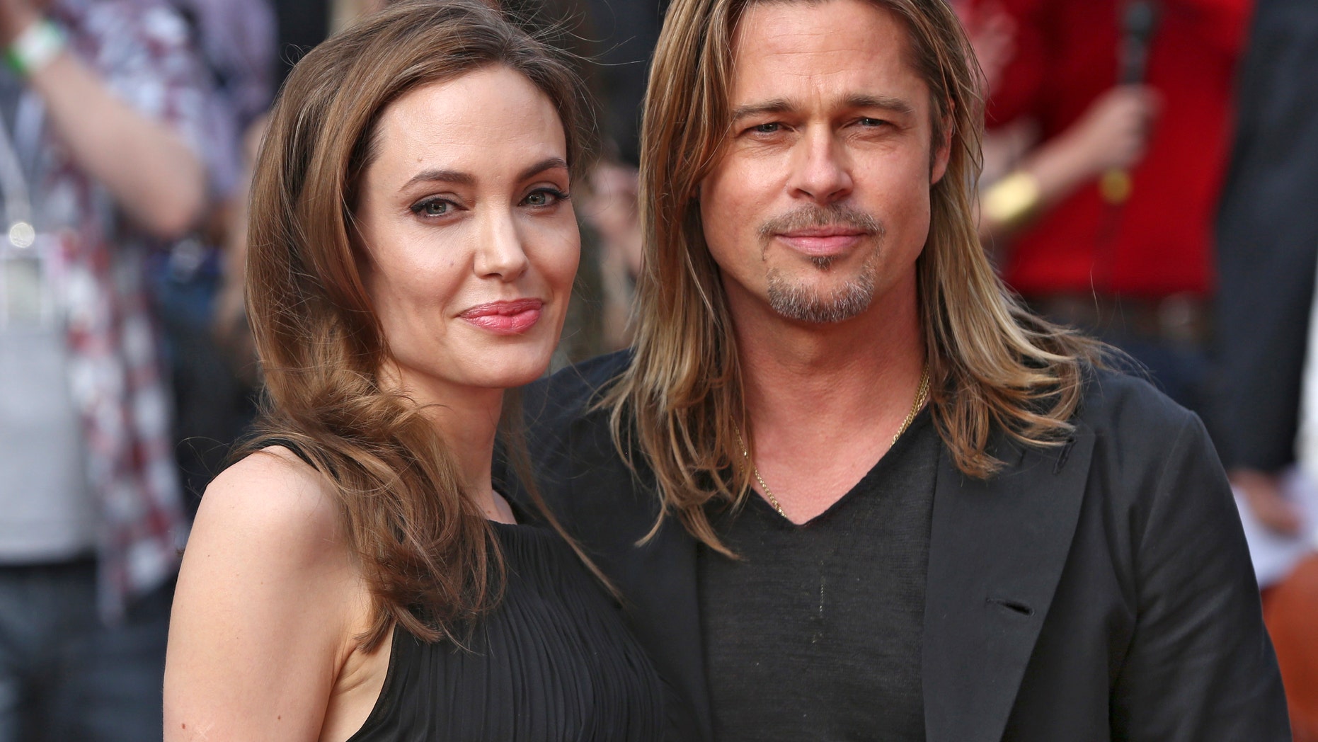 Angelina Jolie poses with Brad Pitt at her first public appearance after announcing she underwent a double mastectomy in February 2013. Jolie tested positive for the BRCA gene.